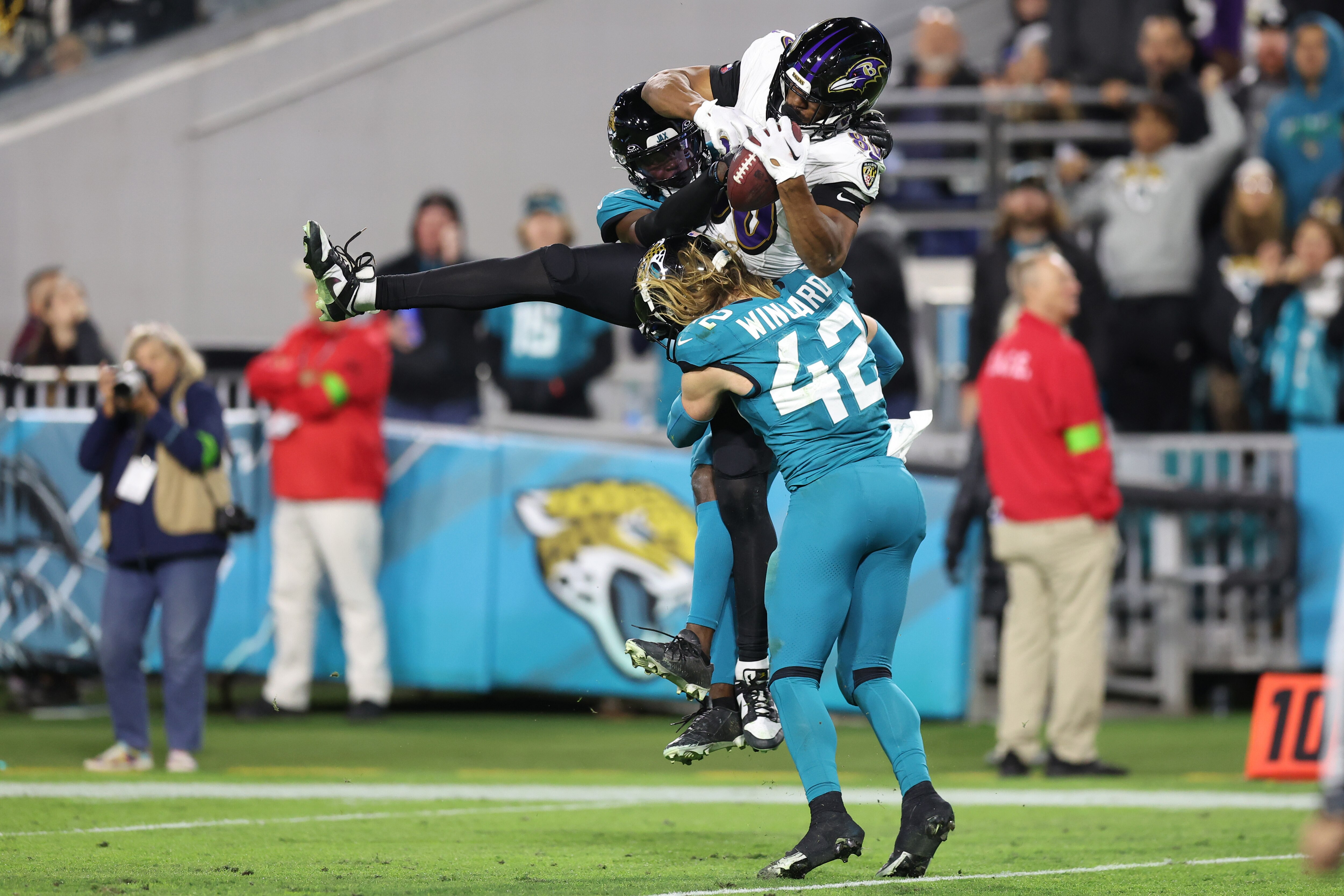 Ravens tight end Isaiah Likely makes a third-quarter reception between Jaguars defenders Darious Williams and Andrew Wingard Sunday night during Baltimore's 23-7 victory at Jacksonville.
