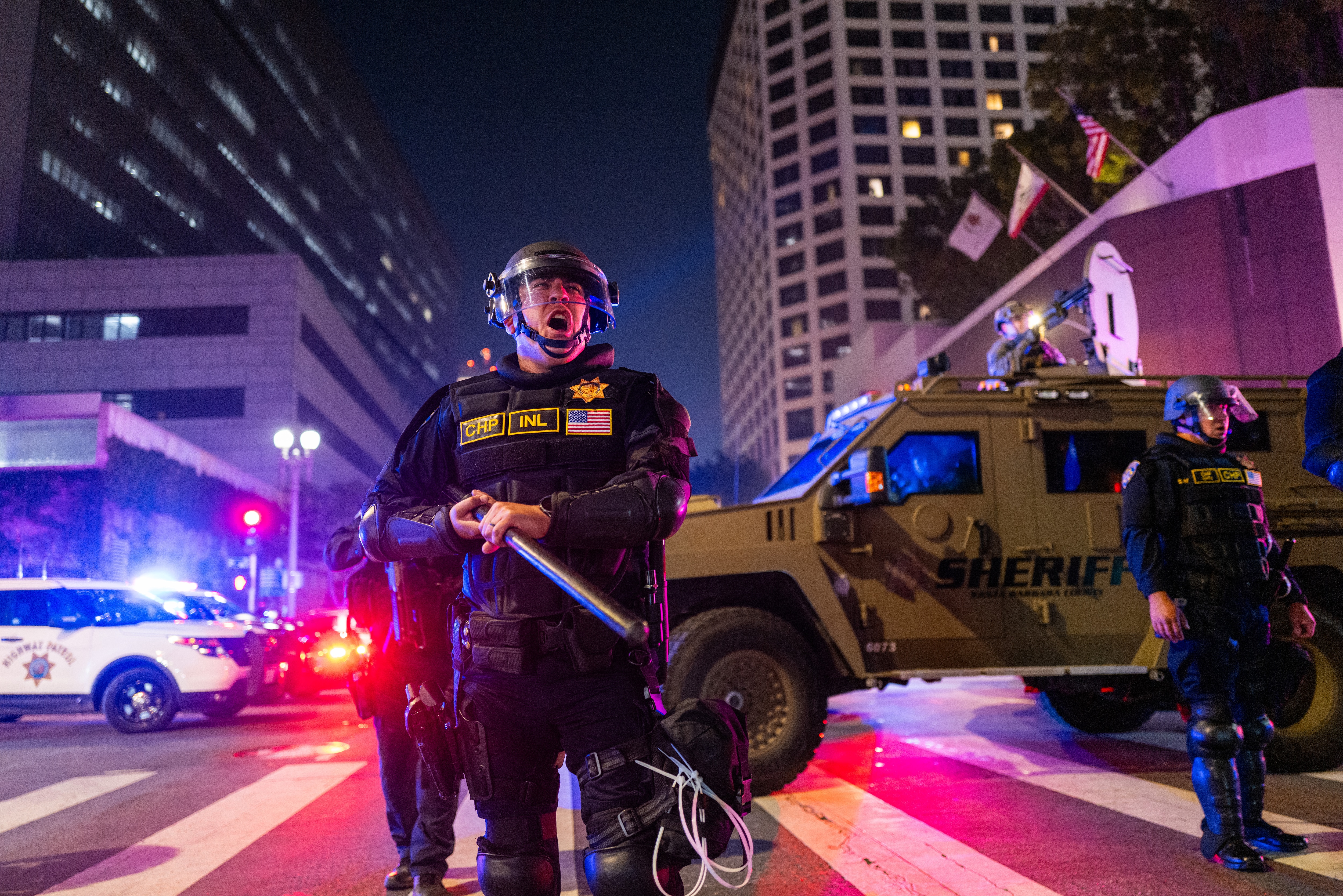 LOS ANGELES, CALIFORNIA - JUNE 09: Police engage with protesters in the evening following three days of clashes after a series of immigration raids last Friday on June 09, 2025, in Los Angeles, California. Tensions in the city remain high after the Trump administration called in the National Guard against the wishes of city leaders.