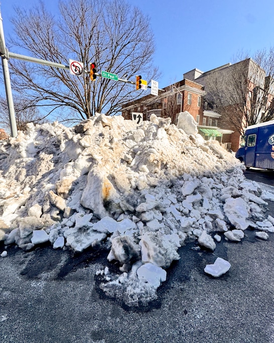 A large pile of snow and ice at the intersection of St. Paul Street and E 33rd Street in Baltimore's Charles Village neighborhood.