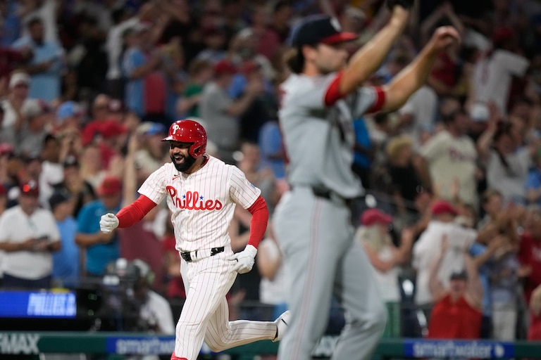 Philadelphia Phillies' Derek Hill, left, reacts after hitting a grand slam against Washington Nationals pitcher Tom Cosgrove during the seventh inning.