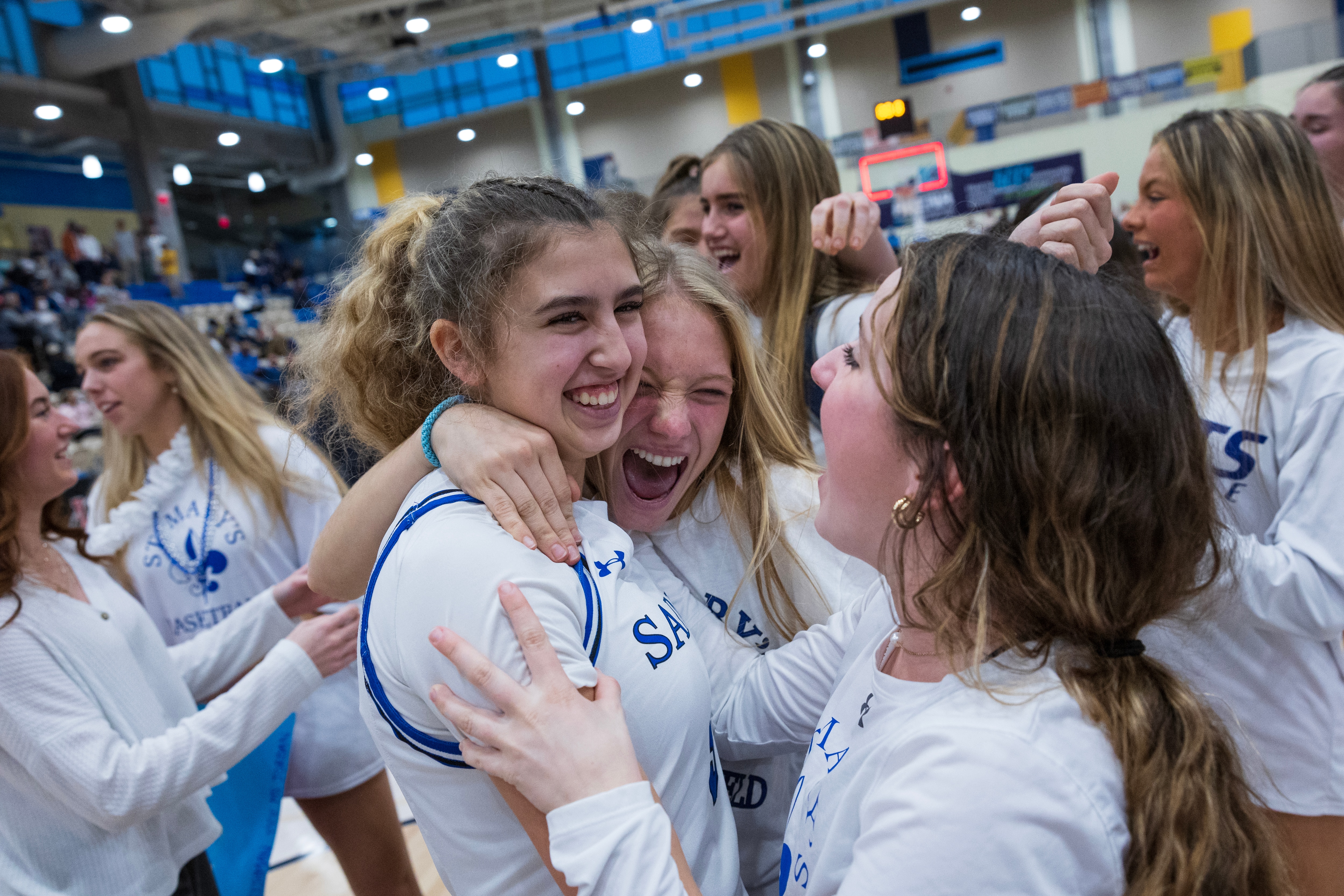St. Mary’s players embrace following their victory during the IAAM B Girls Championship game in Bel Air, Md., on Monday, February 20, 2023. St. Mary’s defeated St. Timothy’s 68-58 in regulation time.