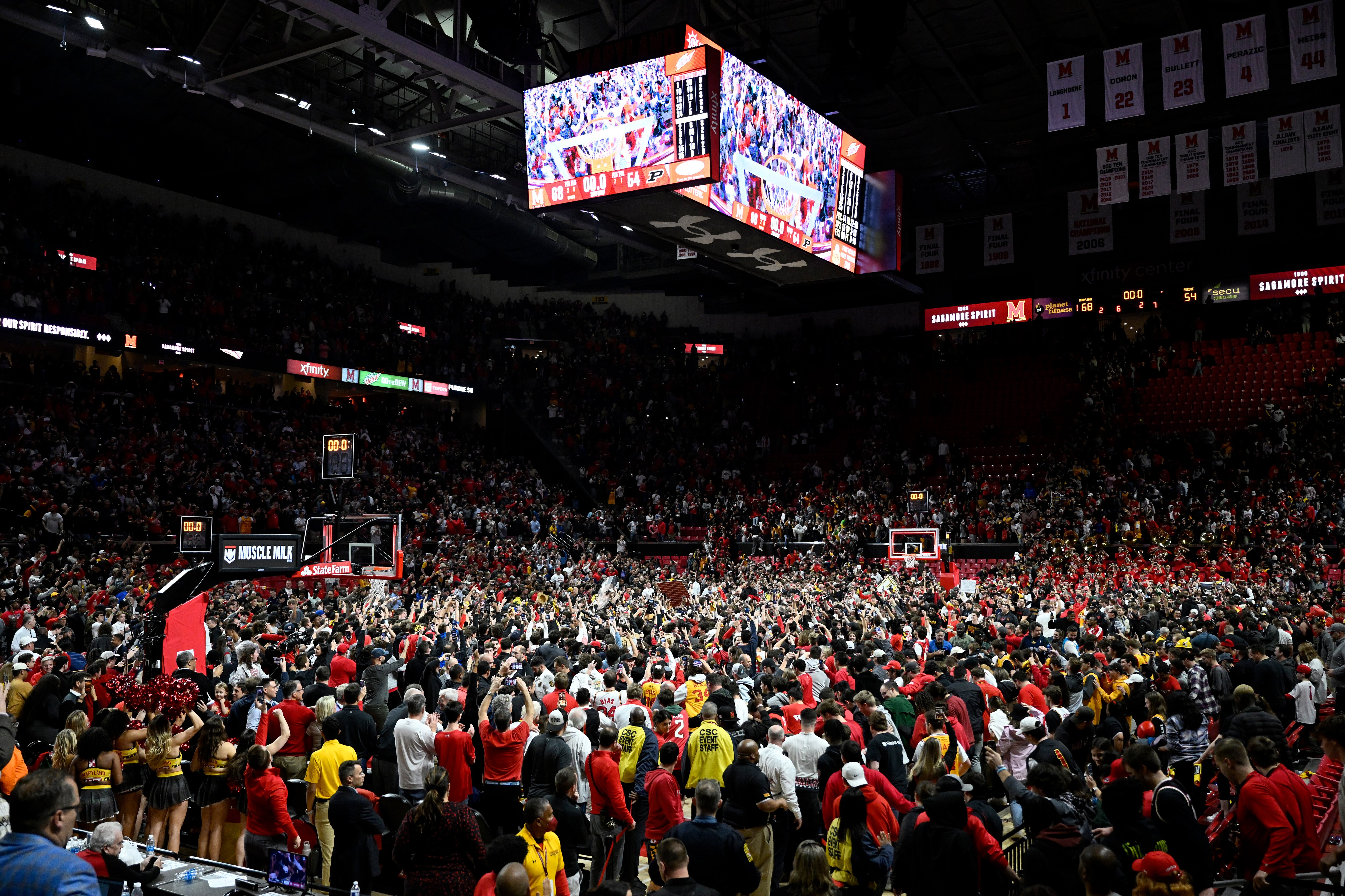Fans storm the Xfinity Center court during a Maryland men's game in February. A leak in the roof caused postponement of a women's game Saturday.