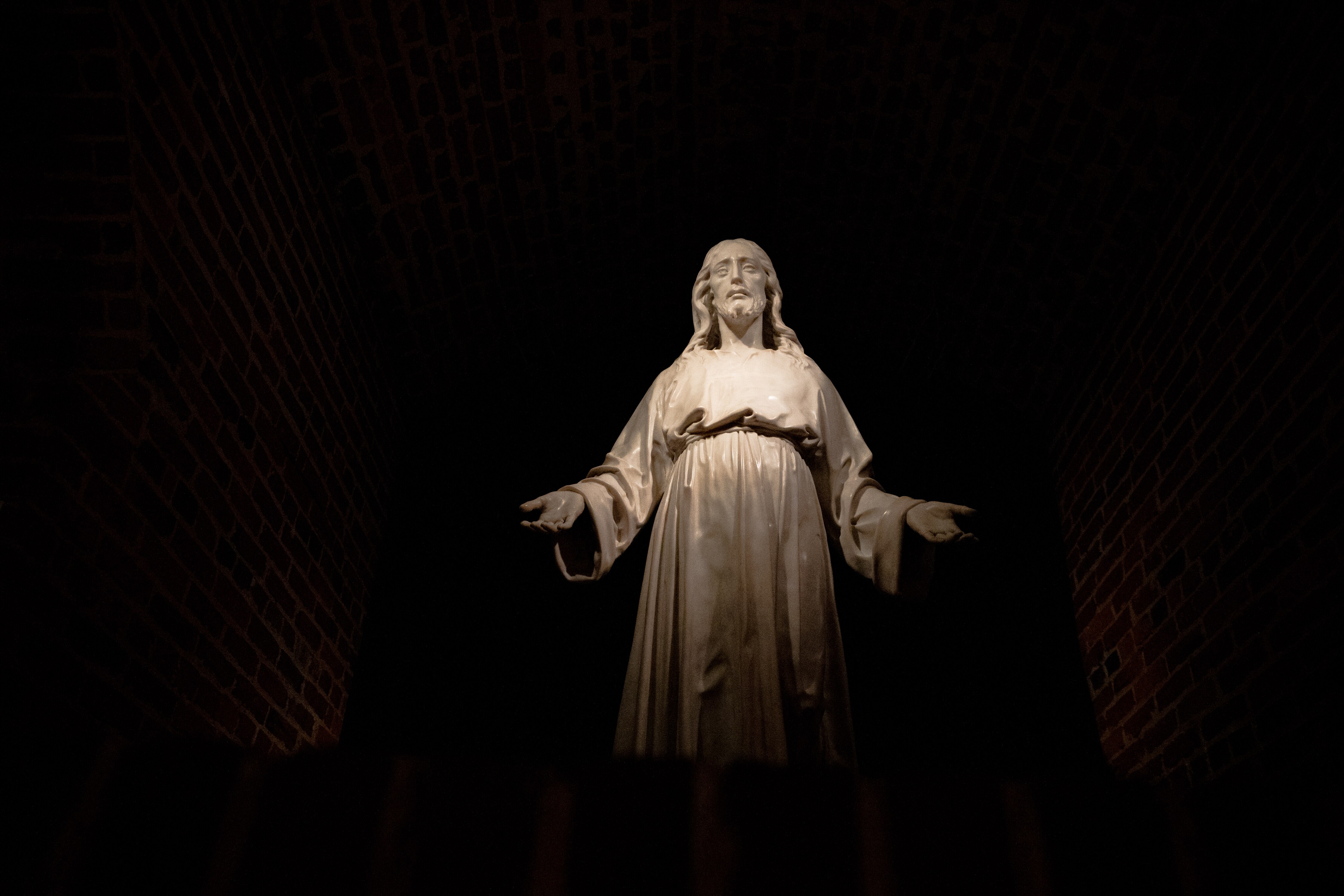 A statue of Jesus Christ symbolically welcomes visitors as they enter the basement crypt, located in The Baltimore Basilica, Baltimore, Md., on December 2, 2022.