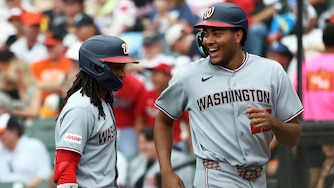 Nationals' James Wood, right, celebrates with teammate CJ Abrams, left, after scoring during the third inning of a game against the Orioles on June 28.
