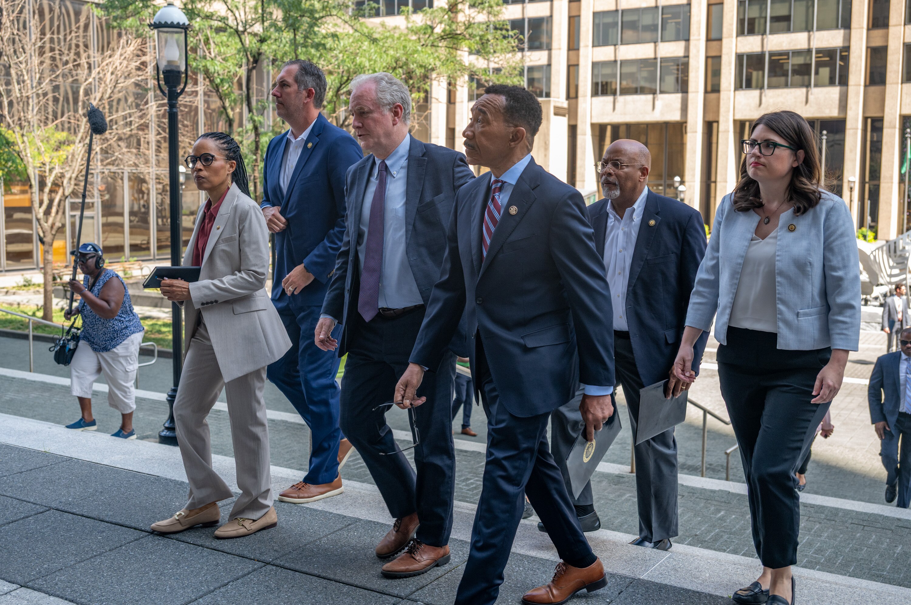 Members of Maryland’s congressional delegation walk up the steps of the George H. Fallon Federal Building in Baltimore on Monday morning.
