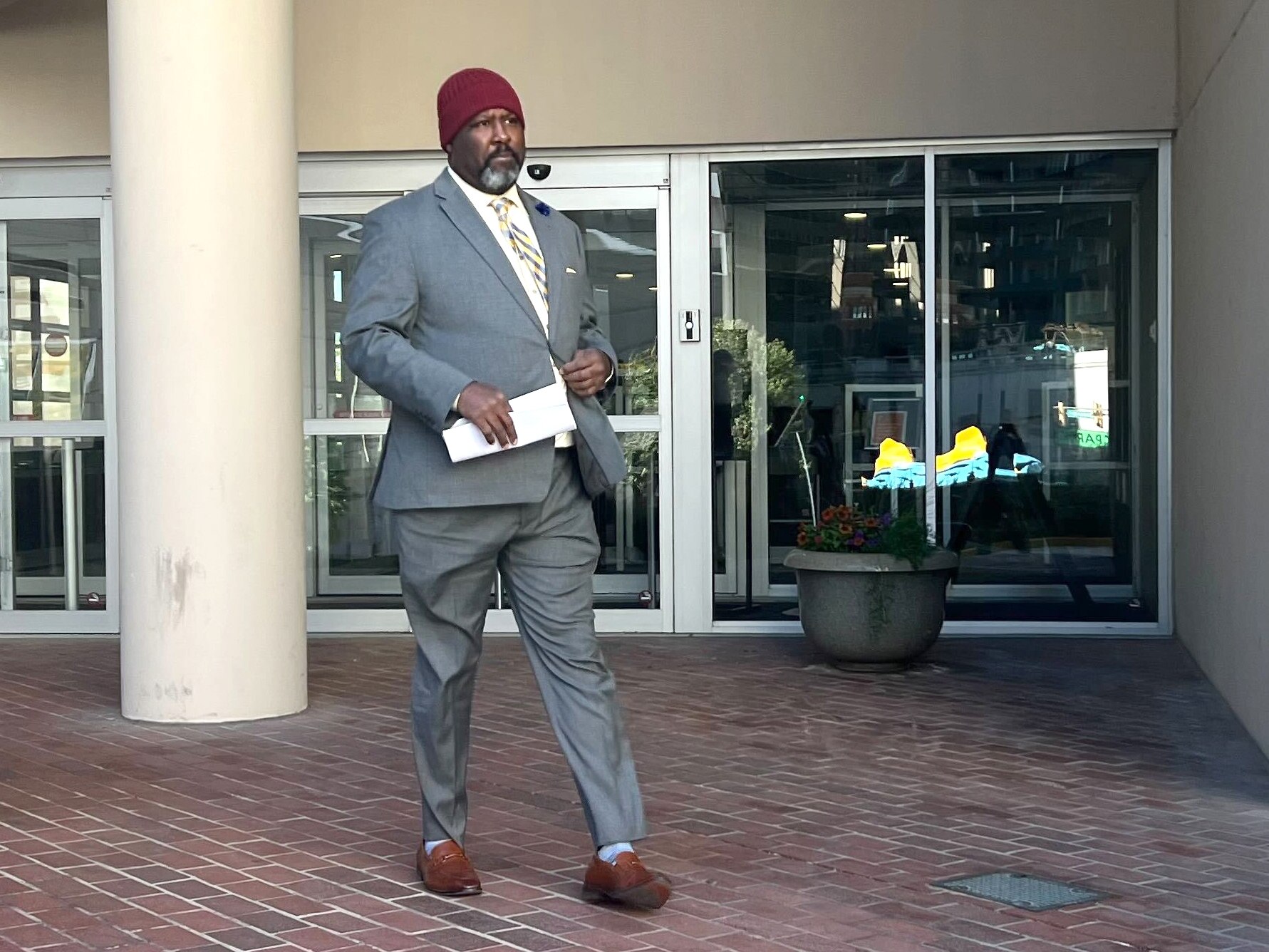 Former Dunbar football coach Lawrence Smith leaves US District Court in Baltimore on Friday afternoon after pleading guilty to wire fraud and tax evasion related to $215,000 in overtime pay he collected as a city schools police officer for hours that he did not actually work.
