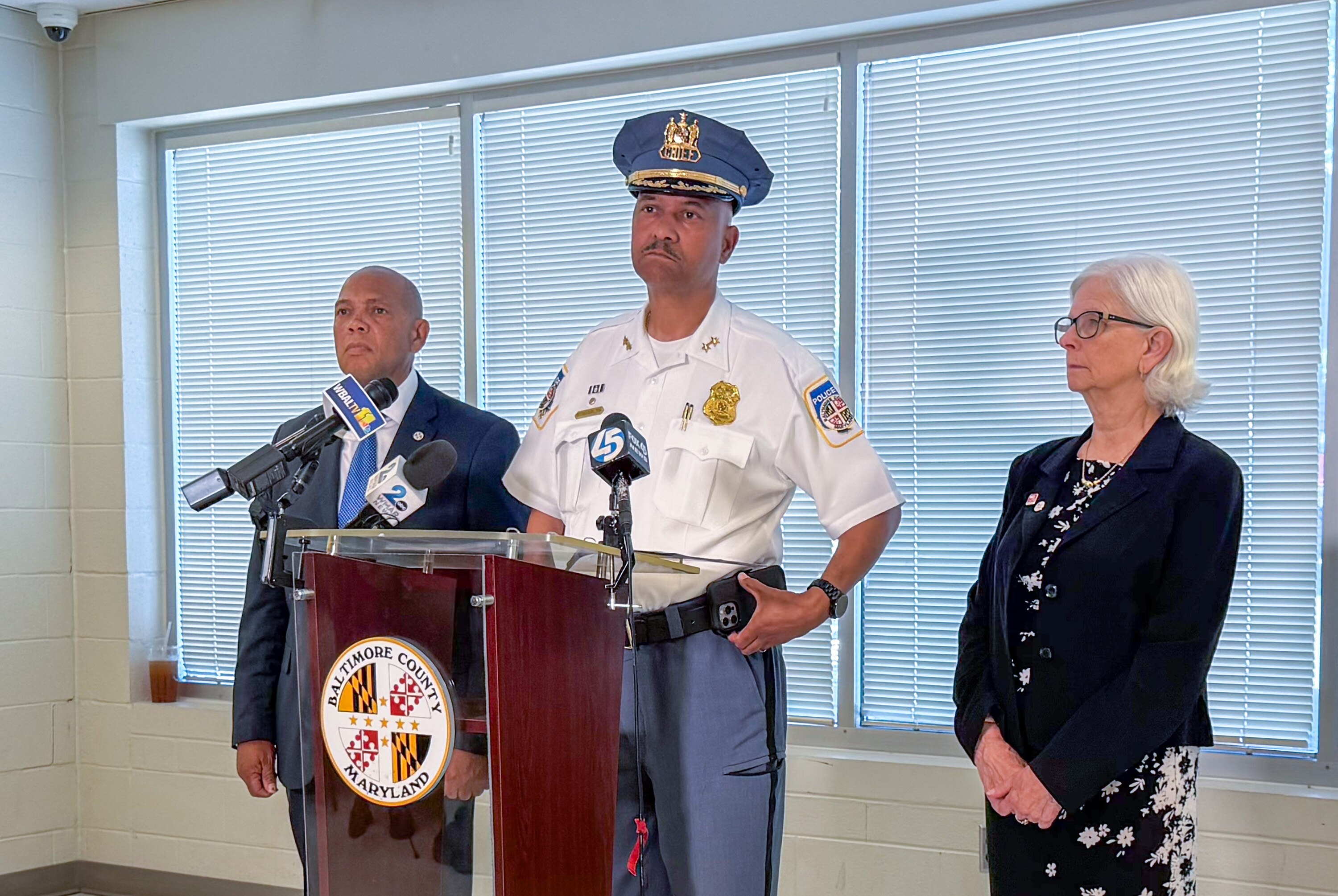 Baltimore County Police Chief Robert McCullough, flanked by Councliman Julian Jones and County Executive Kathy Klausmeier, details the arrest of a 16-year-old in the double murder in Gwynn Oak.