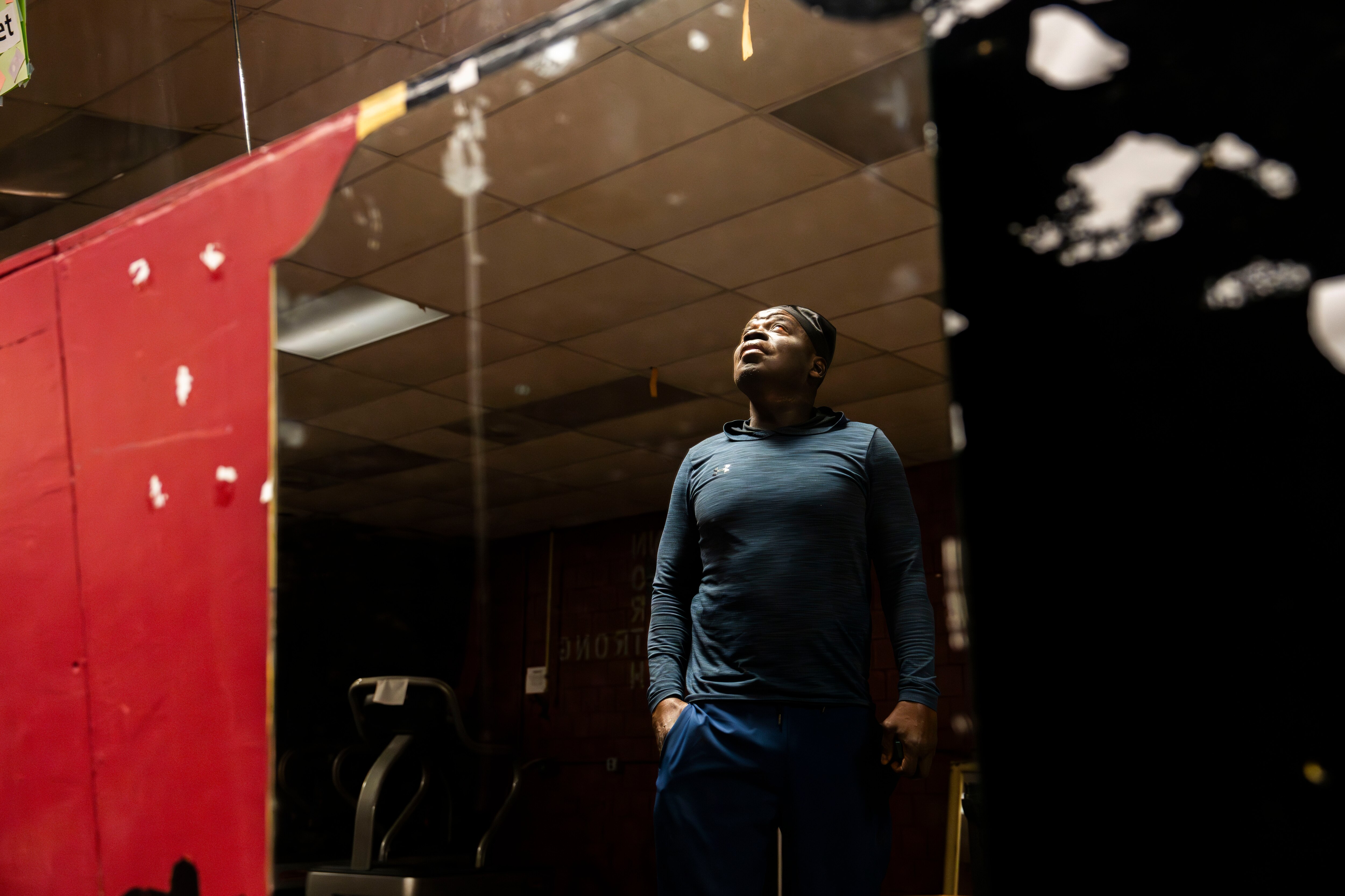 Will Boston stands in the empty gym at Penn North after his early morning run. In recovery, Boston started a makeshift gym for others going through treatment.