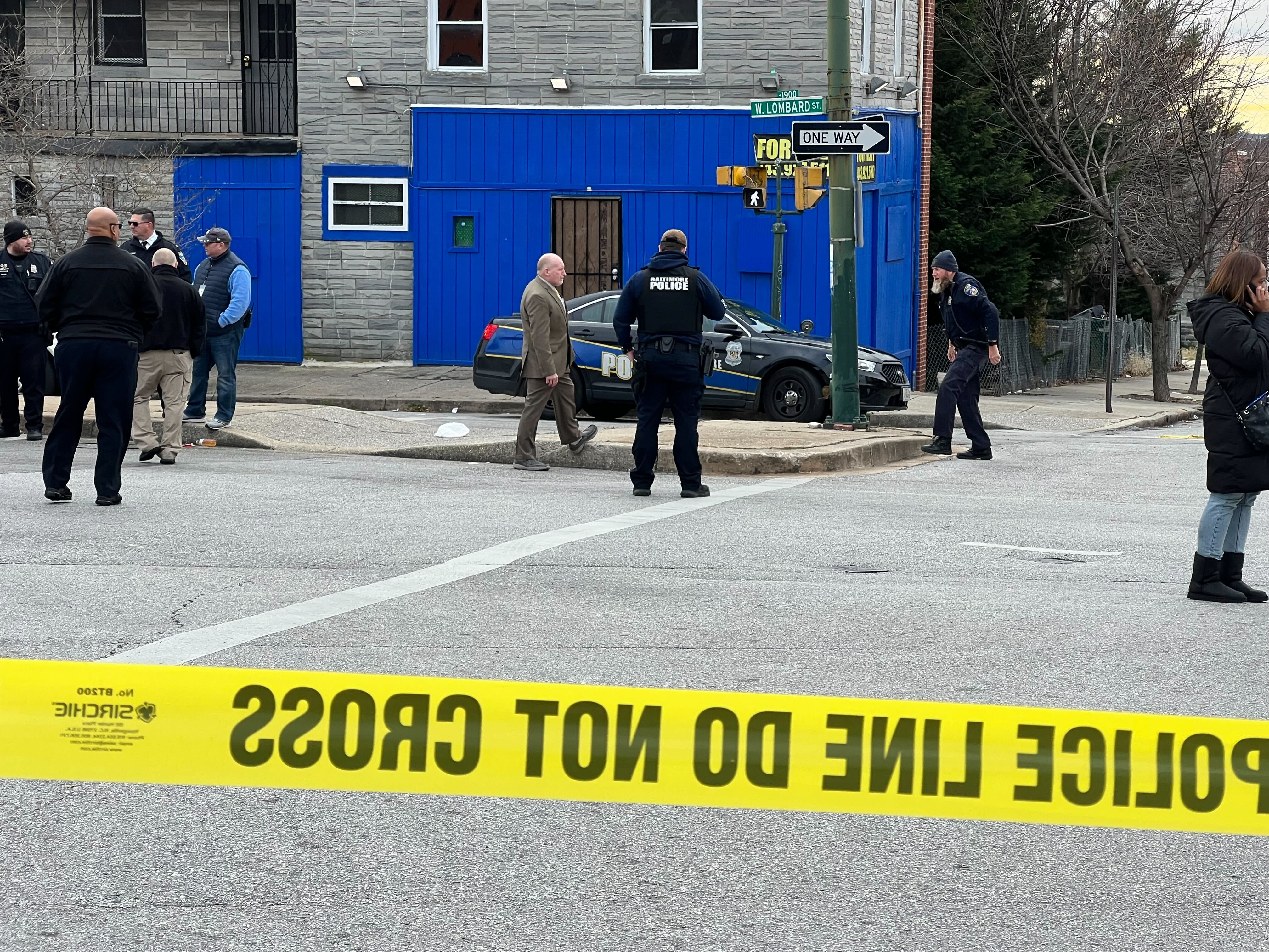 Baltimore Police officers stood at a scene in the 2000 block of West Pratt Street on Dec. 30, 2023, in response to an officer involved shooting.