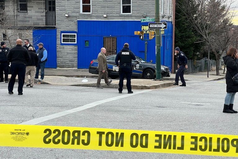 Baltimore Police officers stood at a scene in the 2000 block of West Pratt Street on Dec. 30, 2023, in response to an officer involved shooting.