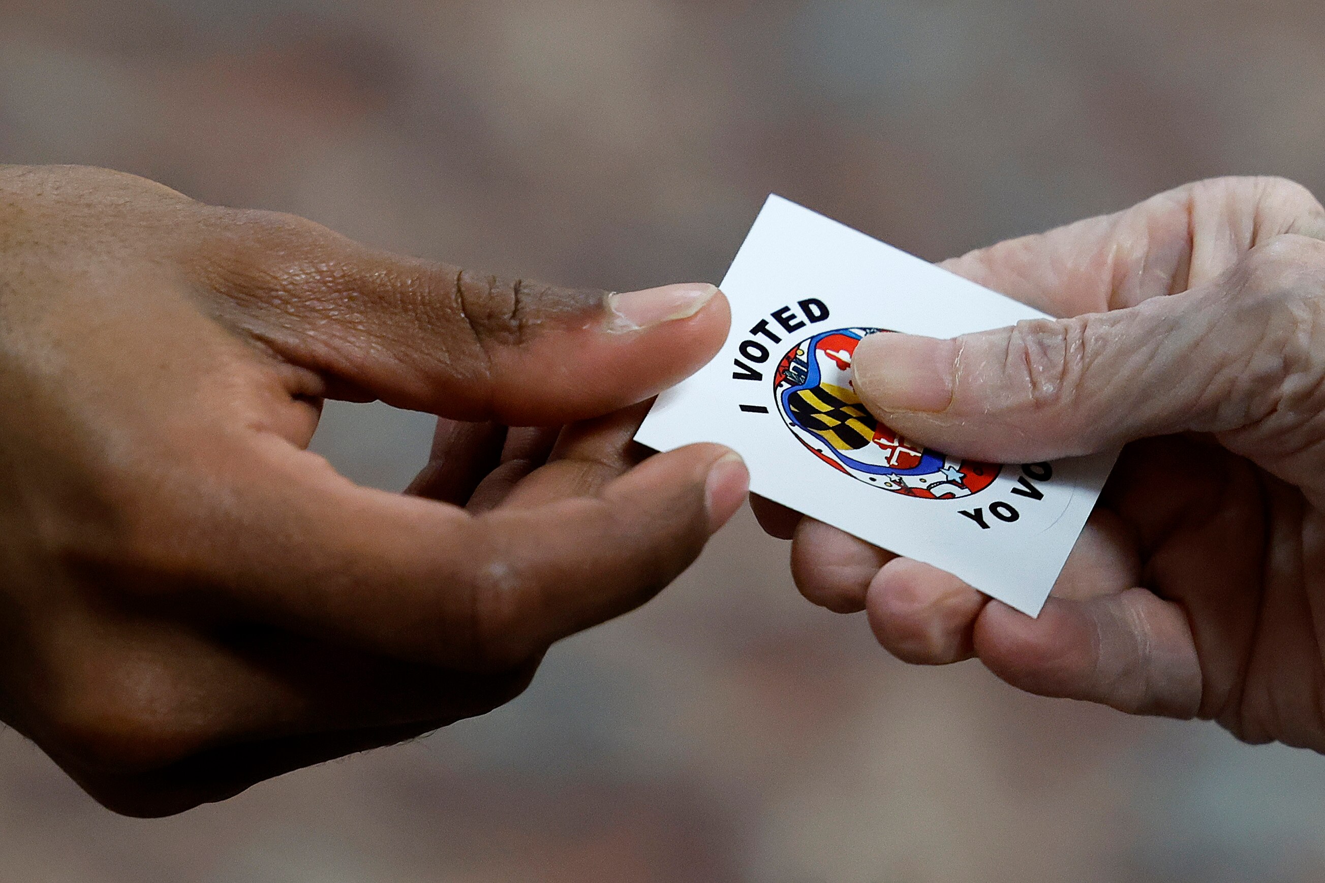 Voters get "I Voted" stickers after casting their ballots at the early voting location in the ballroom of the Sandy Spring Volunteer Fire Station.