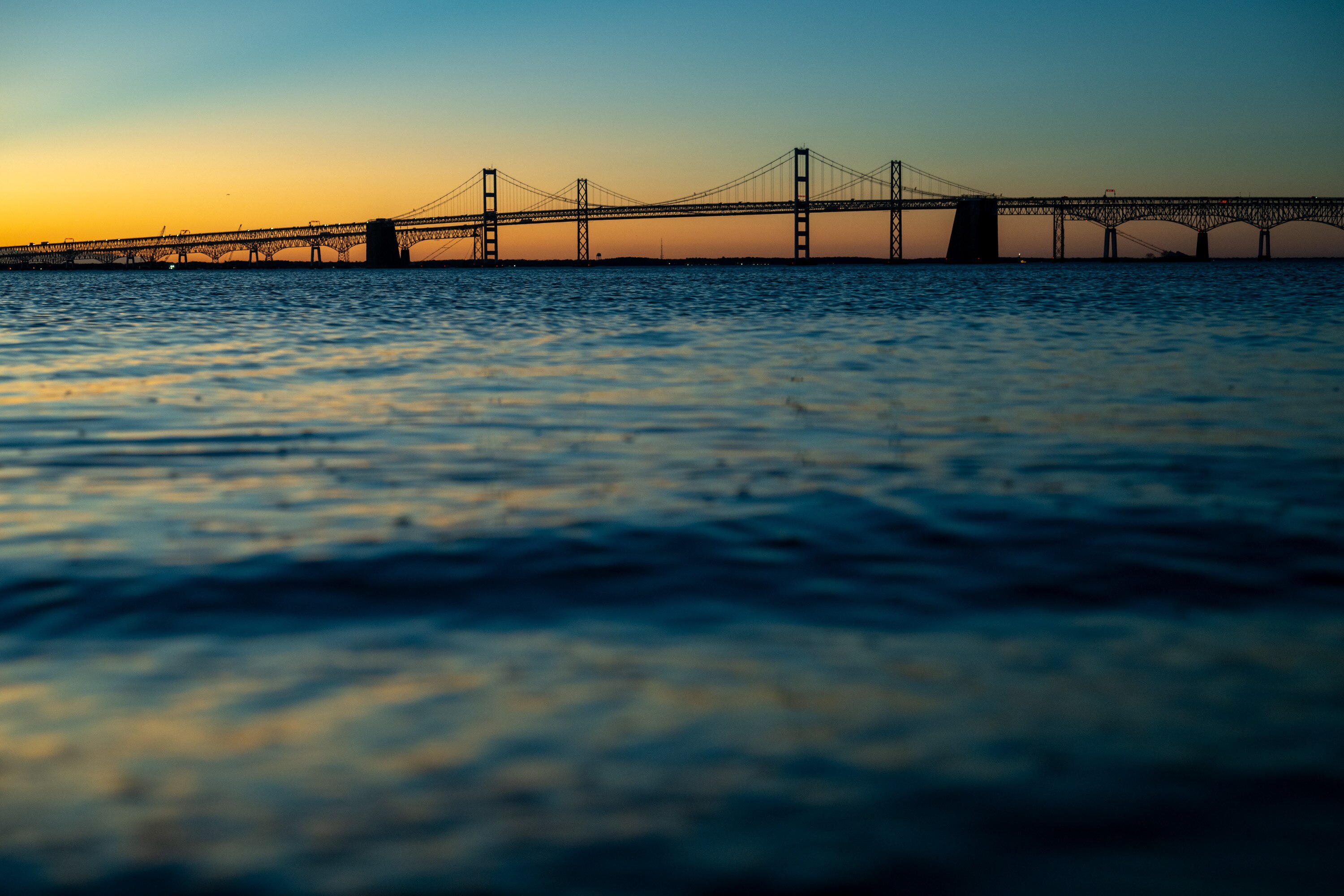 The Chesapeake Bay Bridge is seen from the beach at Sandy Point State Park before sunrise on February 7, 2025.