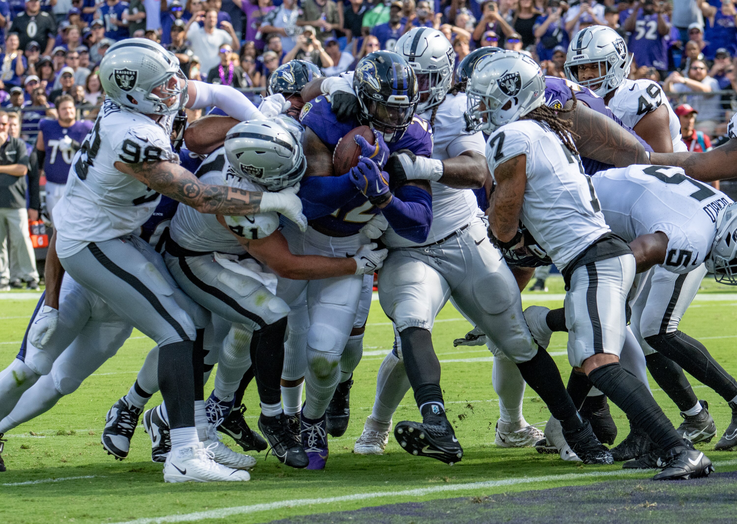 Ravens running back Derrick Henry moves through a crowd of Raiders defenders to score a 3-yard touchdown in the fourth quarter.