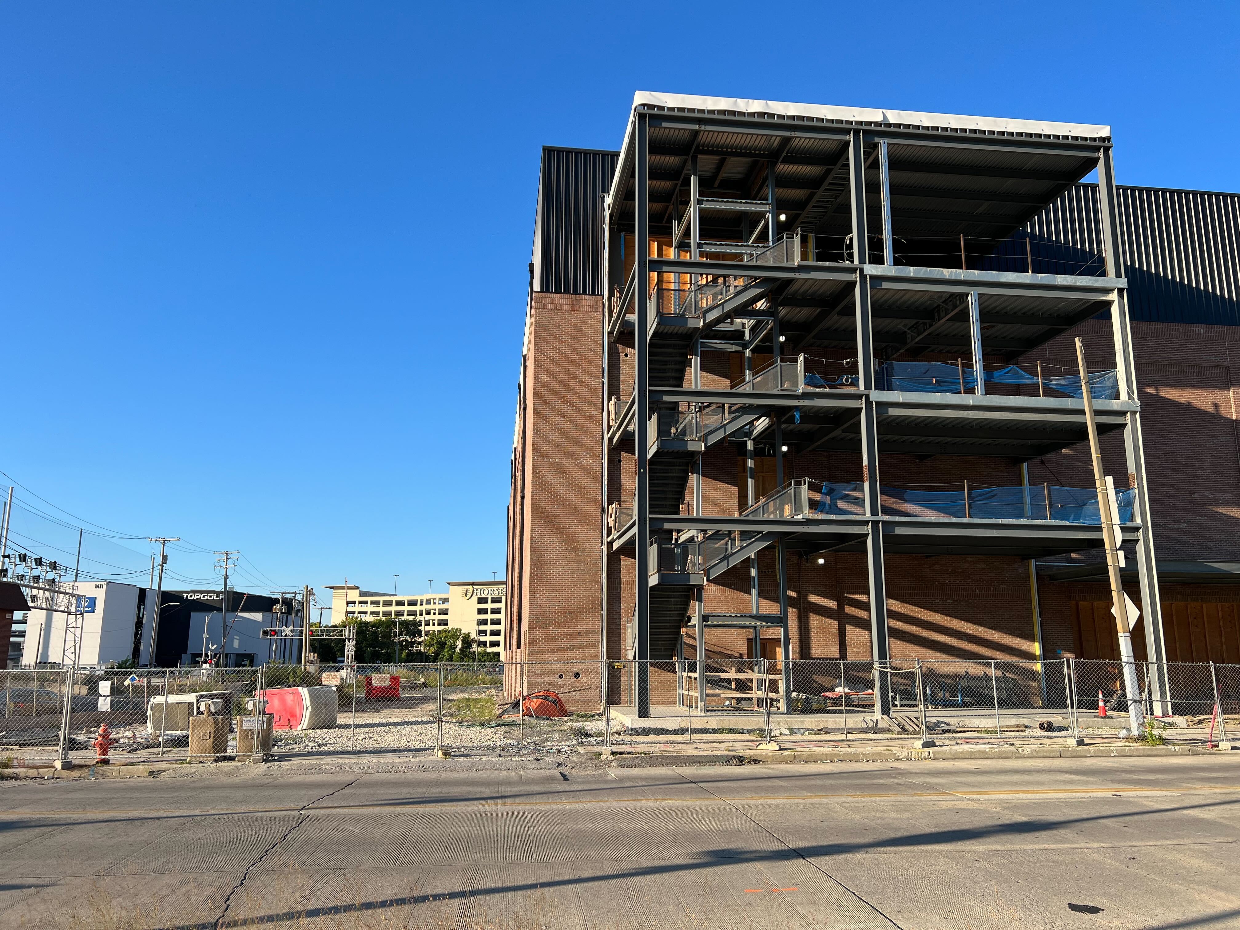 Construction on The Paramount, billed as a $50 million, 3,750-seat concert venue in Baltimore's casino and stadium district, halted earlier this year and new court filings claim their funding has dried up. Seen behind the half-built venue are TopGolf and the Horseshoe Casino