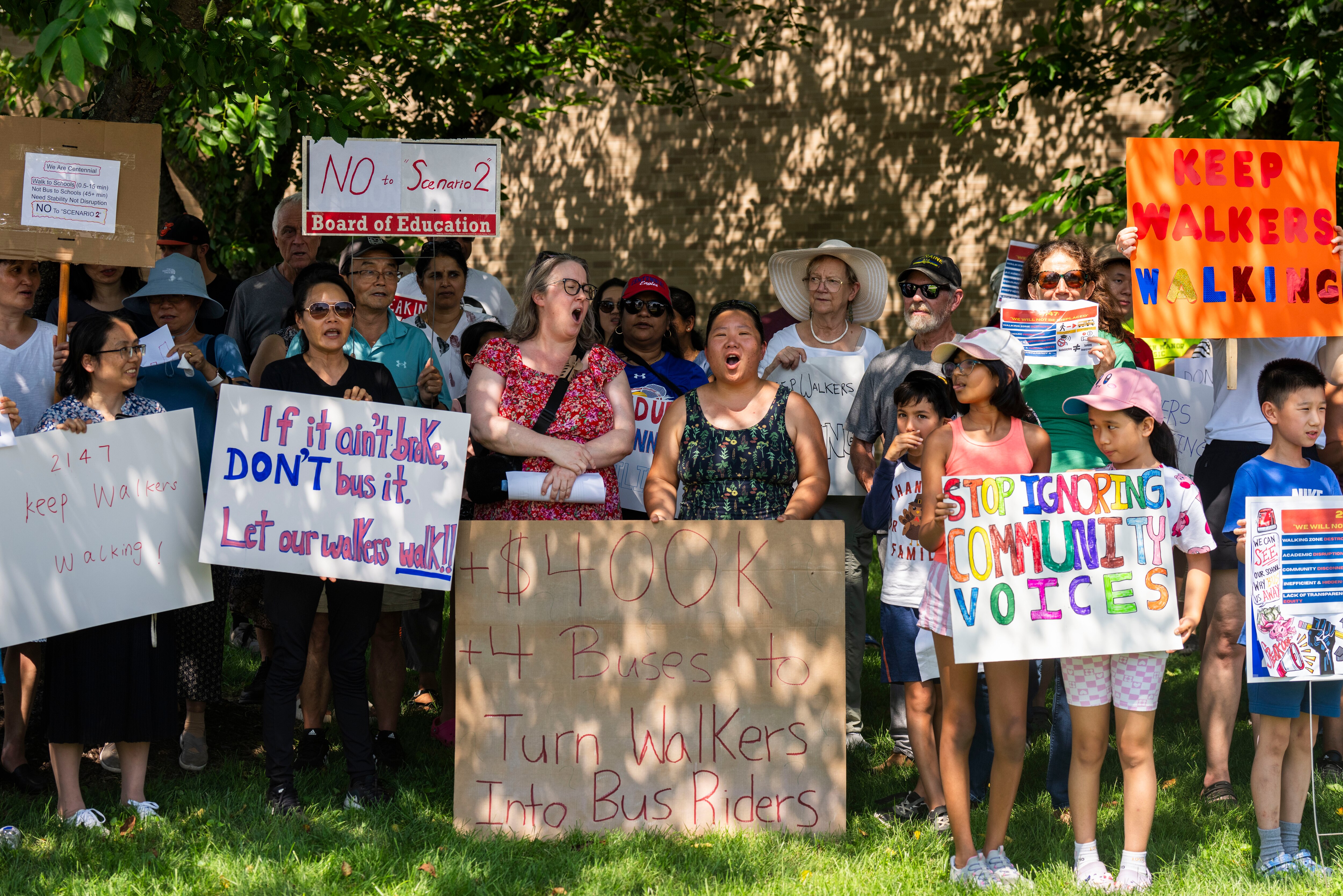 Community parents, Cindy LaFollette, left center, and Bena Zeng, right center, protest ahead of the school board meeting against the redistricting proposals outside of the Howard County school board offices on July 17, 2025. The group says that the district’s “short-sighted” decision to place pre-K programs at over-capacity schools is causing the problem.