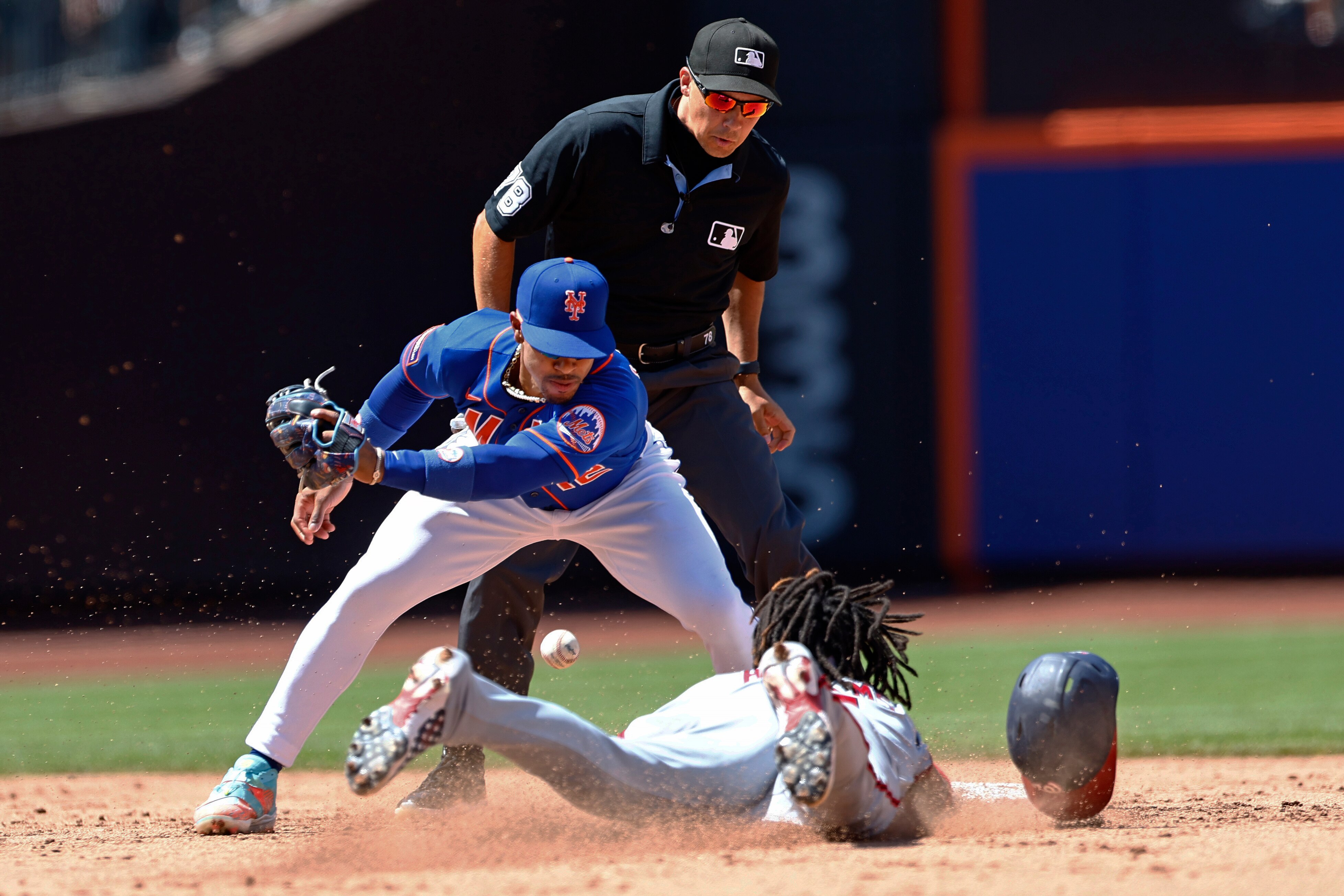 Mets shortstop Francisco Lindor can't field the throw as the Nationals' CJ Abrams steals one of his three bases Sunday in New York.