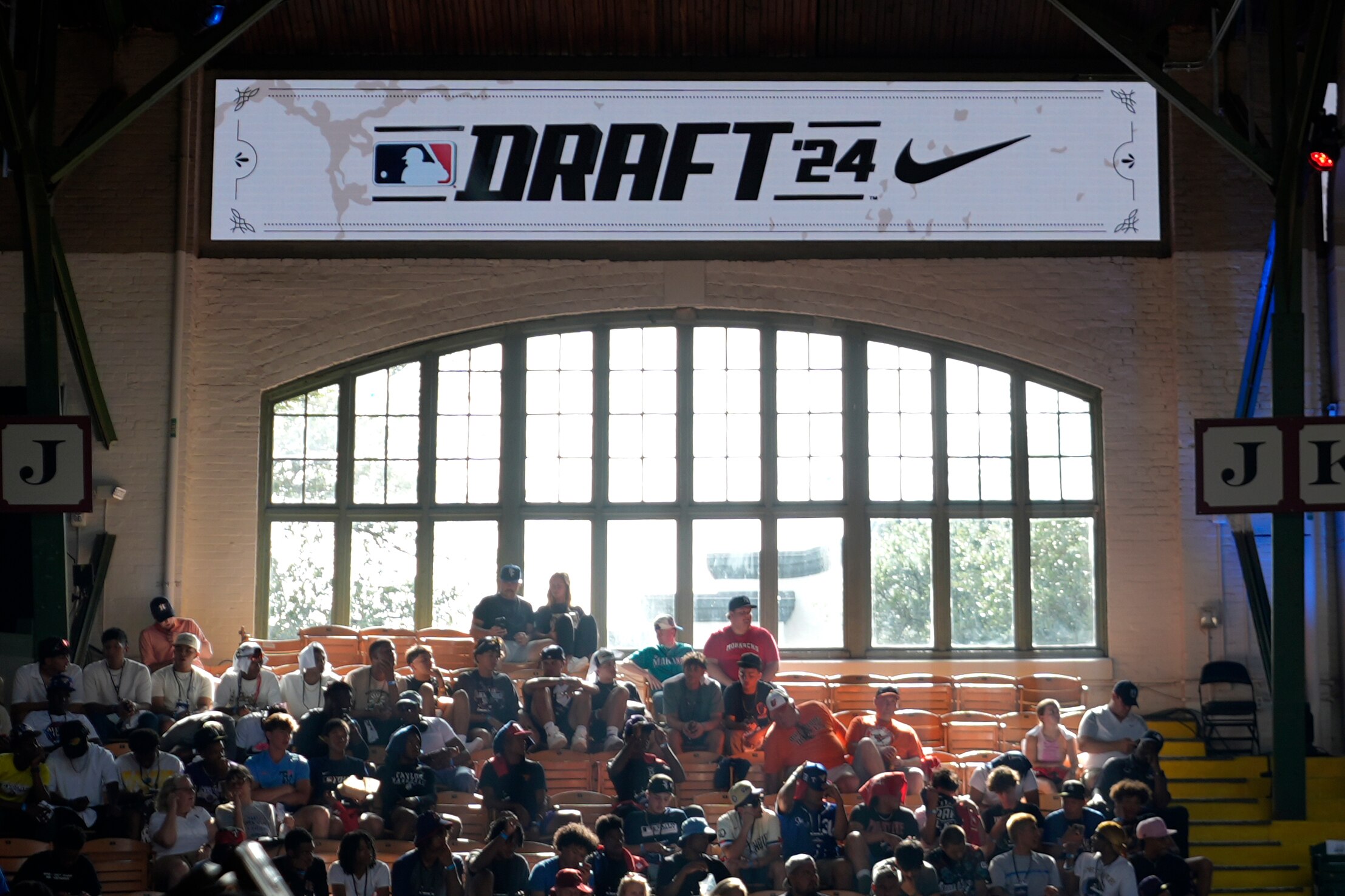 Attendees look on during the MLB baseball draft at the Cowtown Coliseum in Fort Worth, Texas, Sunday, July 14, 2024.