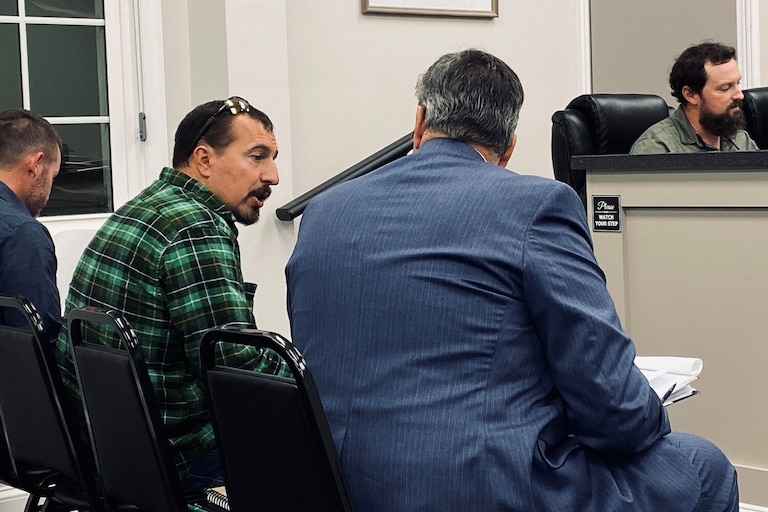 Benjamin Flahart, left, consults with his attorney during a Caroline County Planning Commission meeting in October 2023.
