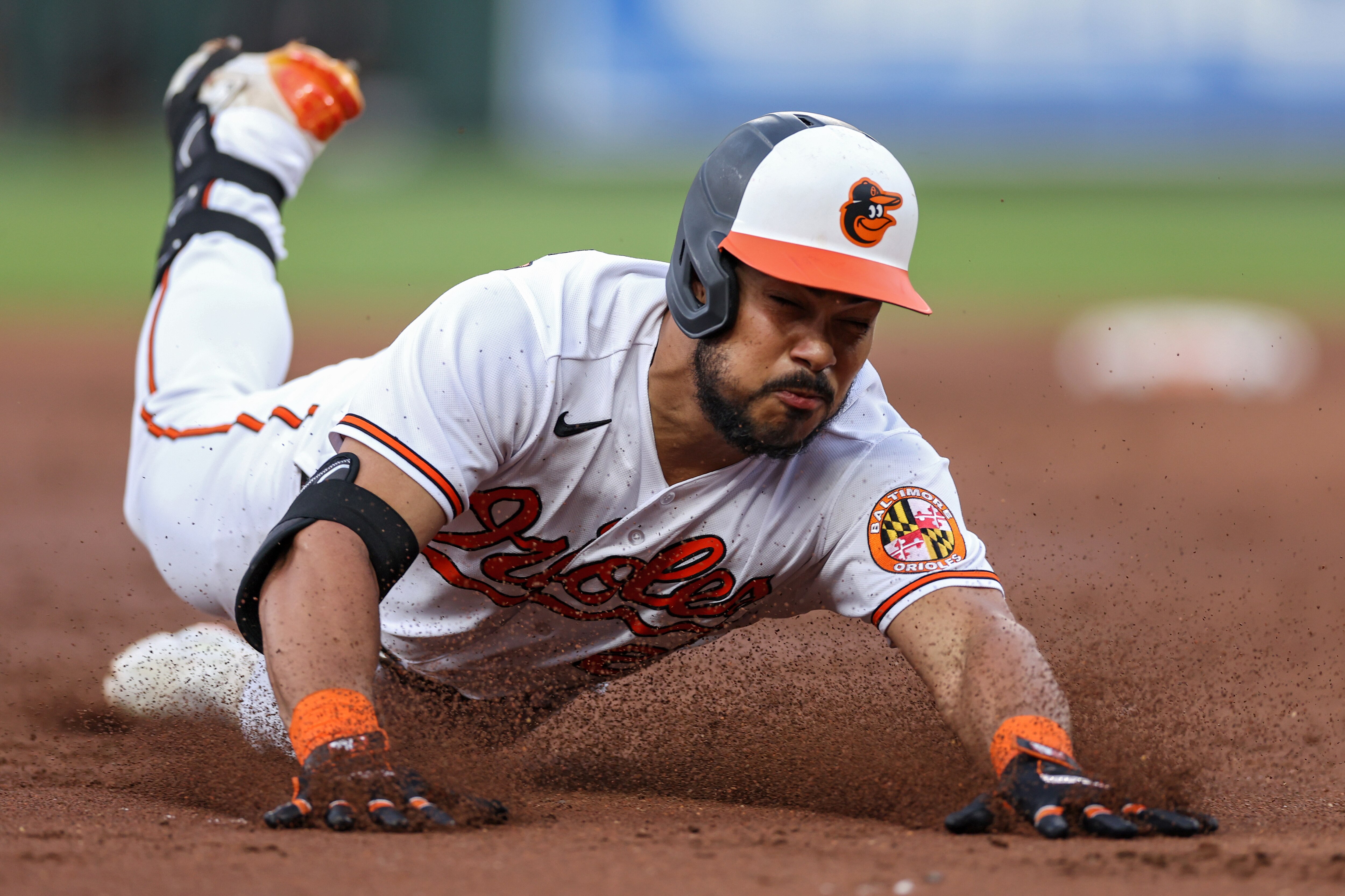 Anthony Santander #25 of the Baltimore Orioles slides into second base after hitting an RBI triple to score three runs against the Cleveland Guardians during the second inning at Oriole Park at Camden Yards on May 30, 2023 in Baltimore, Maryland.