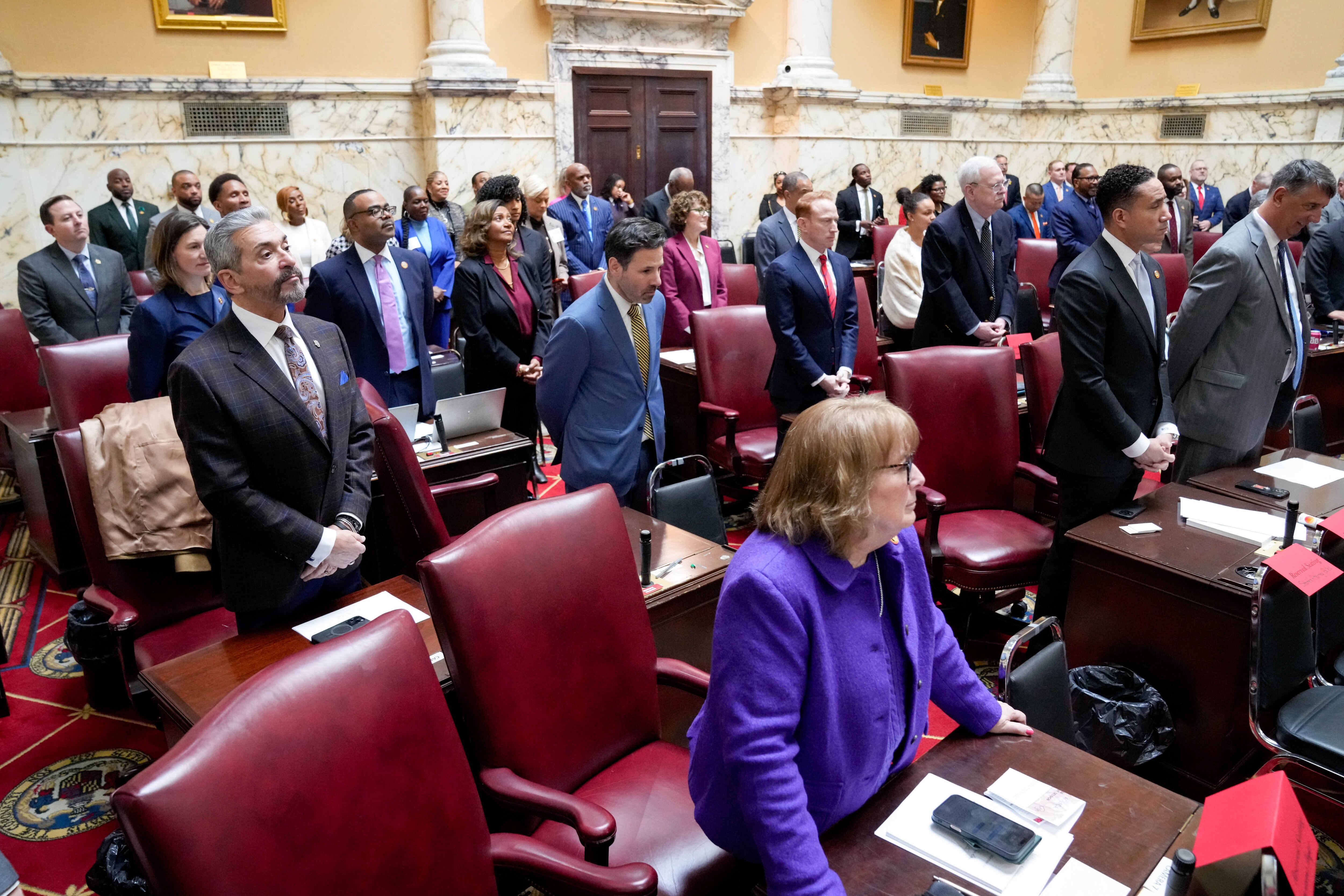 Senators rise during the opening invocation in the Senate chamber of the Maryland State House in Annapolis in January.