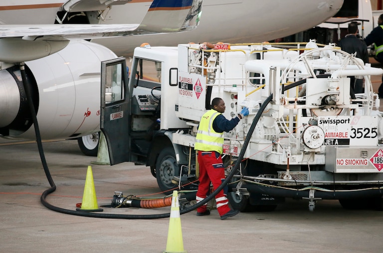 FILE - A worker prepares to fuel a United Express aircraft after it arrived at a gate at Dallas-Fort Worth International Airport, Thursday, Jan. 15, 2015, in Grapevine, Texas. (AP Photo/Tony Gutierrez, File)