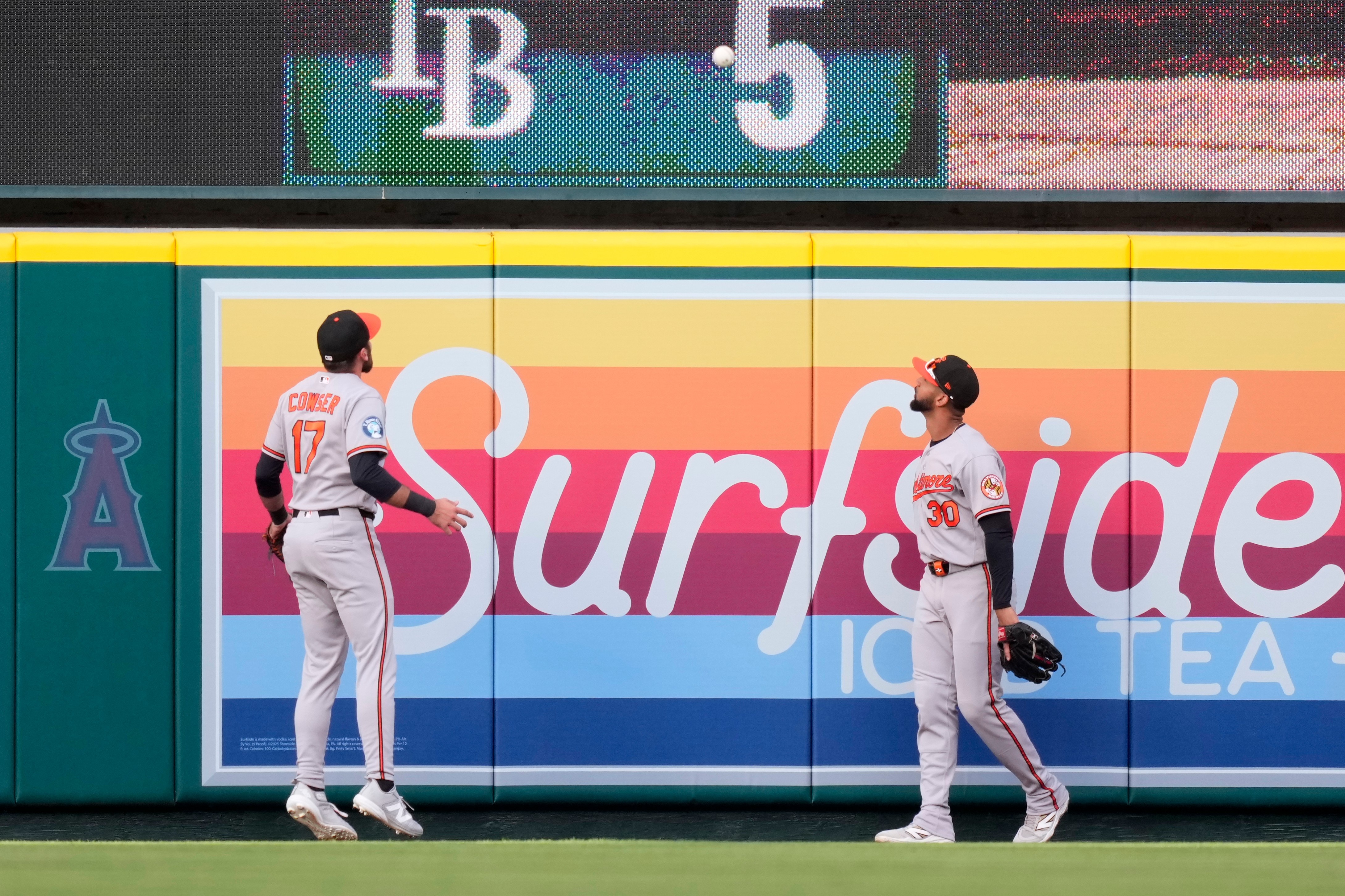 Orioles center fielder Colton Cowser, left, and right fielder Leody Taveras watch as a ball hit by Los Angeles Angels' Nolan Schanuel goes out for a two-run home run during the first inning.