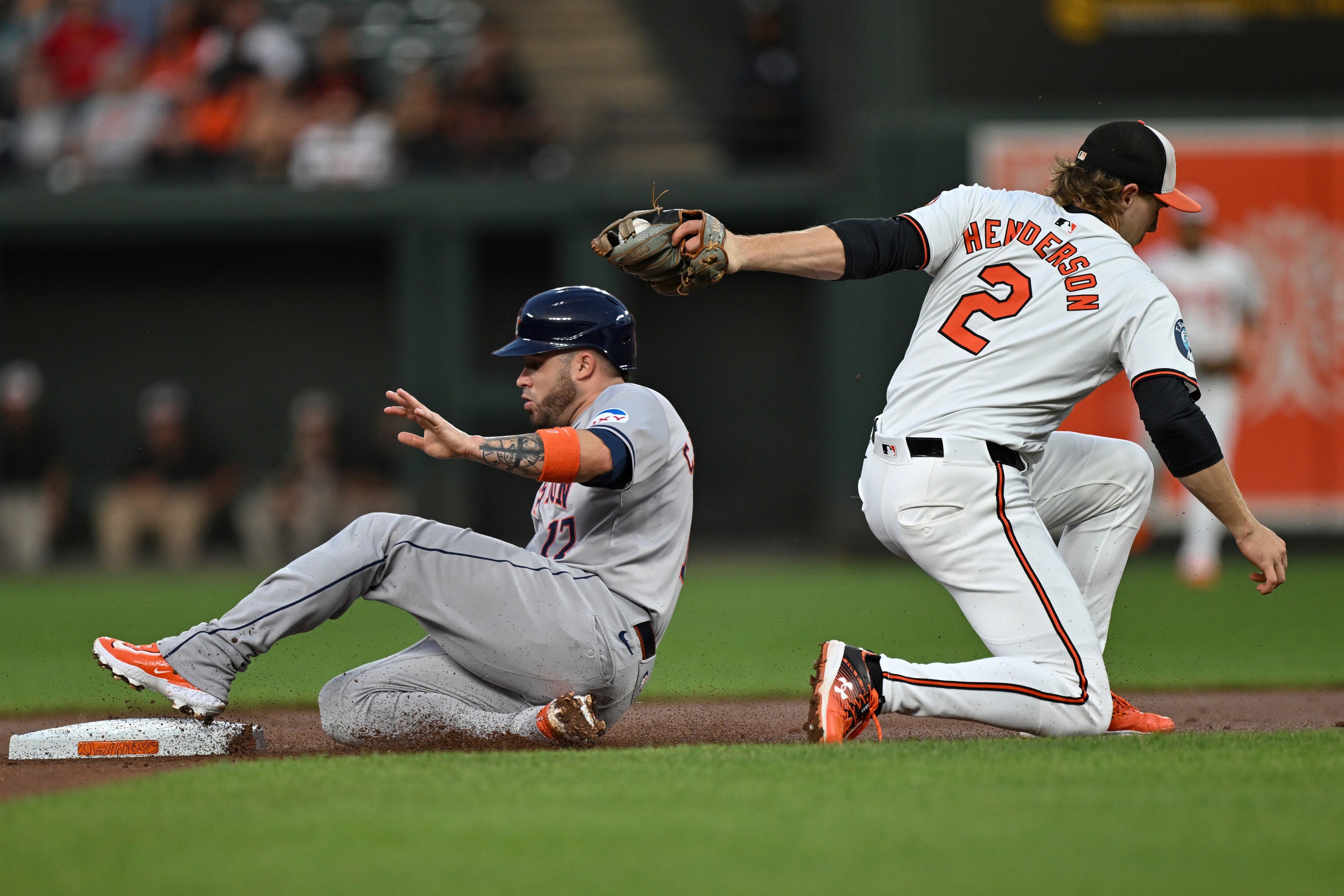 Orioles shortstop Gunnar Henderson tags outs Victor Caratini of the Astros on an attempted steal in the first inning Sunday night.