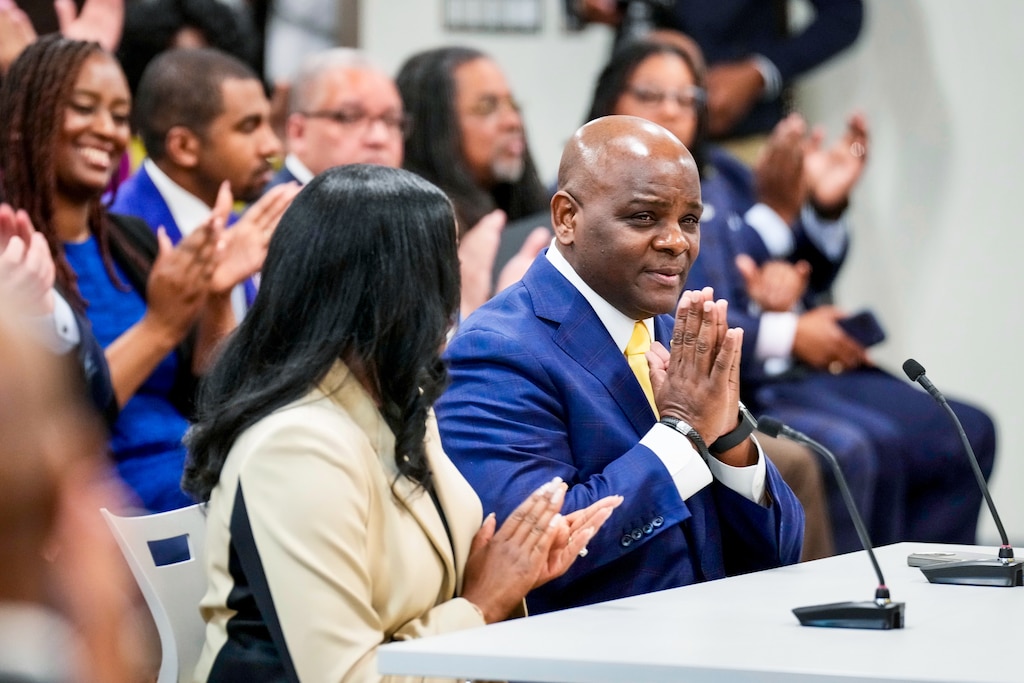 Jermaine Dawson, the incoming CEO of Baltimore City Schools, reacts as the Board of Education unanimously votes him in as the incoming CEO.