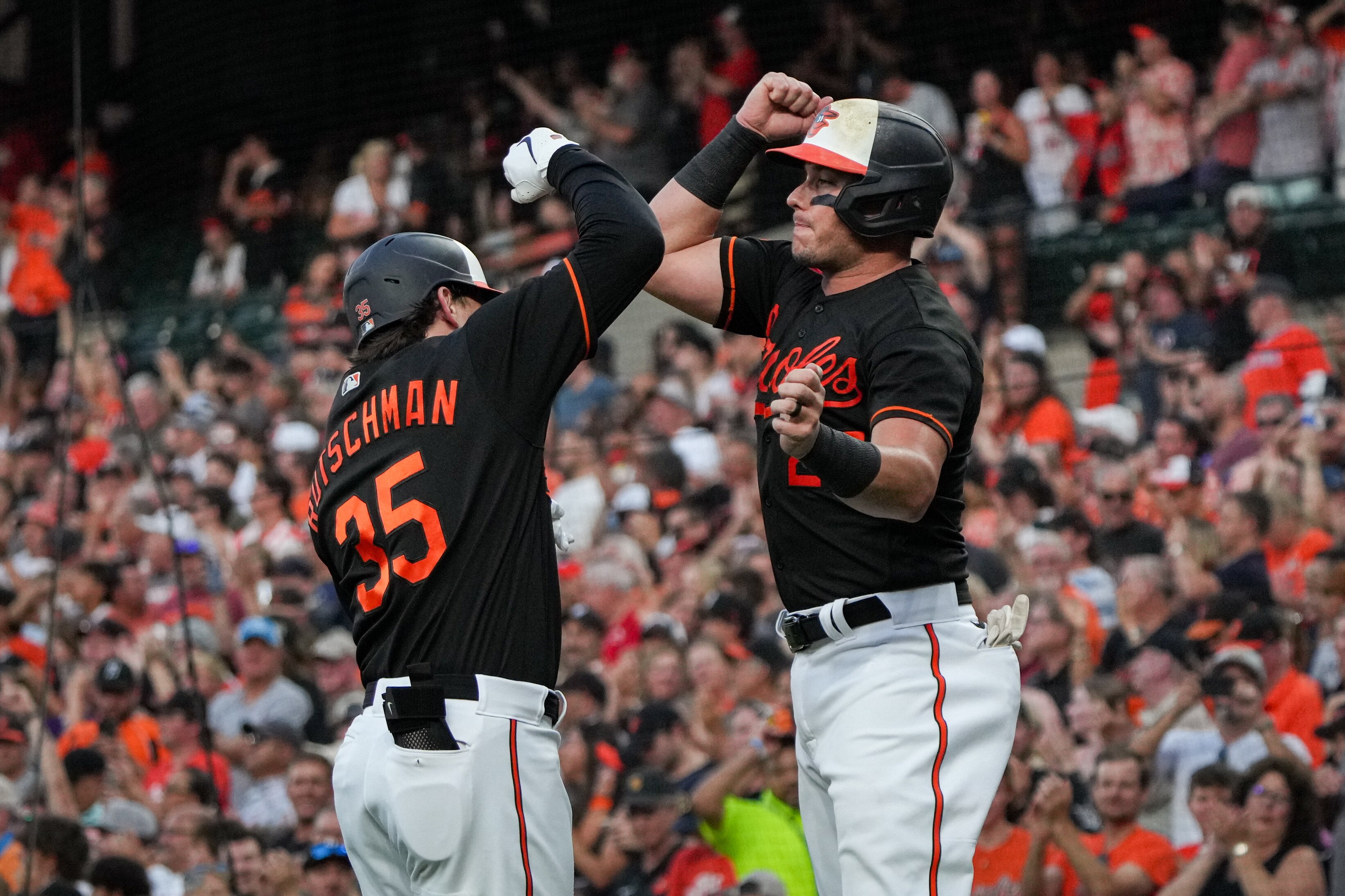 Baltimore Orioles catcher Adley Rutschman (35) celebrates with catcher James McCann (27) after homering in the third inning of a baseball game against the Houston Astros at Orioles Park at Camden Yards in Baltimore on Aug. 8, 2023.