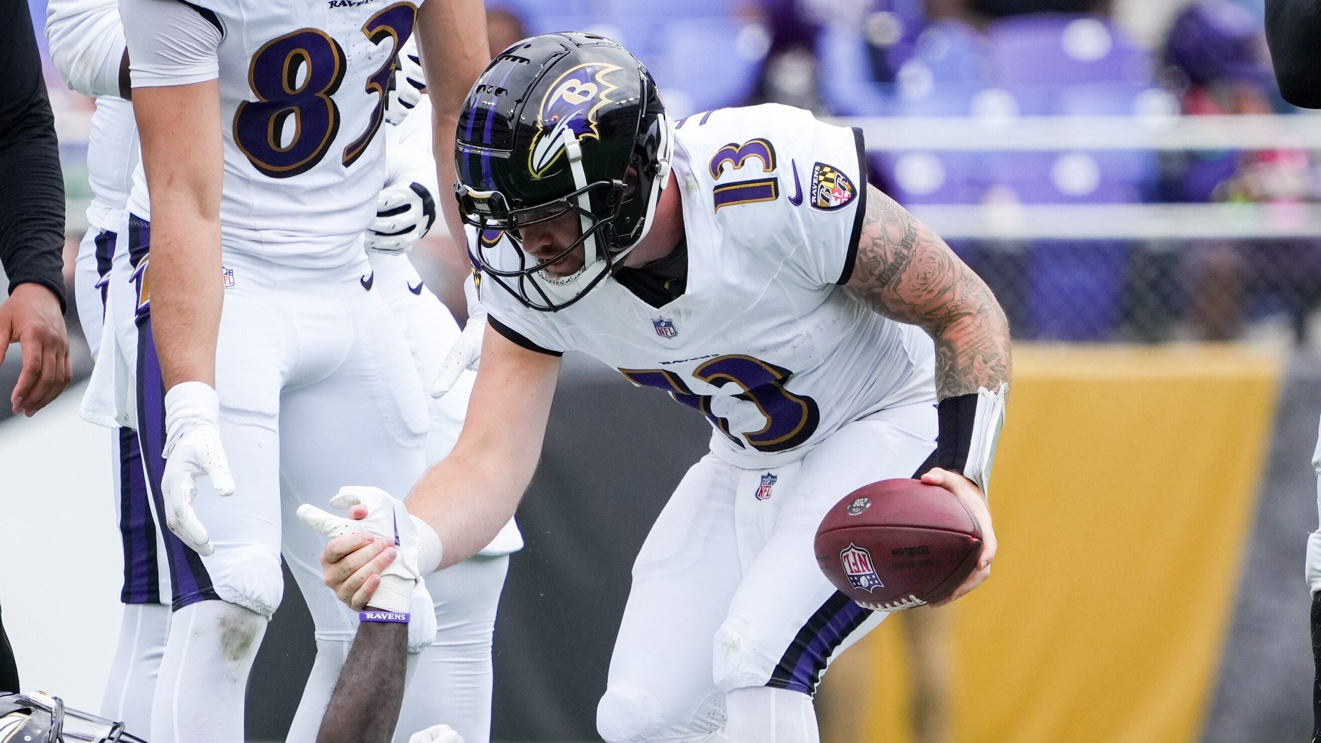 Baltimore Ravens quarterback Devin Leary (13) helps up wide receiver Dayton Wade (18) after a play during a preseason game against the Atlanta Falcons at M&T Bank Stadium in Baltimore on August 17, 2024.