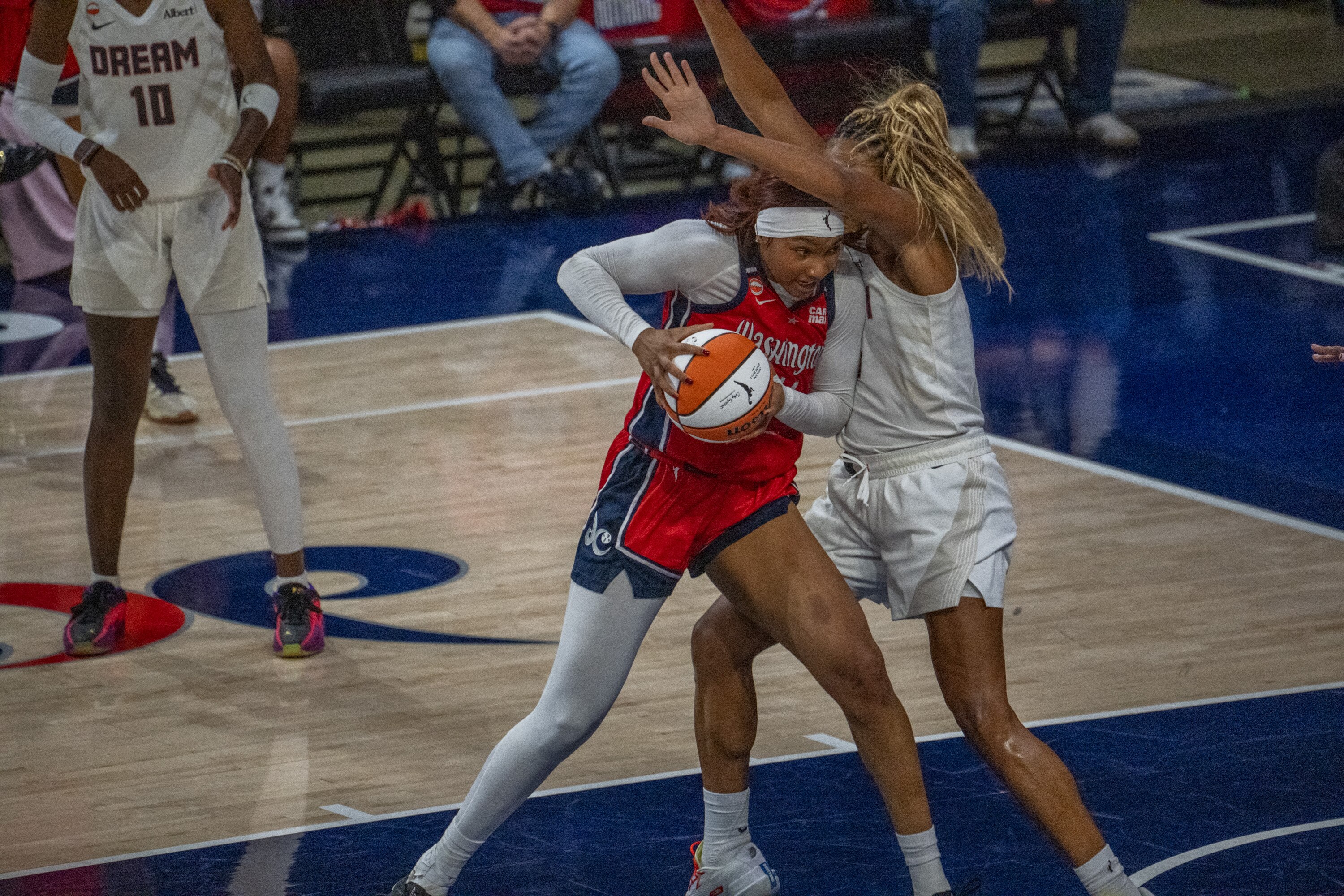 Mystics forward Kiki Iriafen is fouled by Dream forward Naz Hillmon on Wednesday night during Atlanta’s 93-75 victory.
