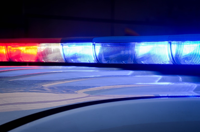 A Baltimore County police vehicle’s lights flash while parked outside of the R Adams Cowley Shock Trauma Center at the University of Maryland in Baltimore, Md. on Thursday, March 13, 2025.