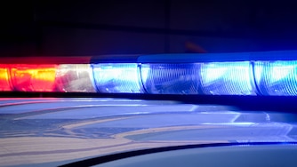 A Baltimore County police vehicle’s lights flash while parked outside of the R Adams Cowley Shock Trauma Center at the University of Maryland in Baltimore, Md. on Thursday, March 13, 2025.