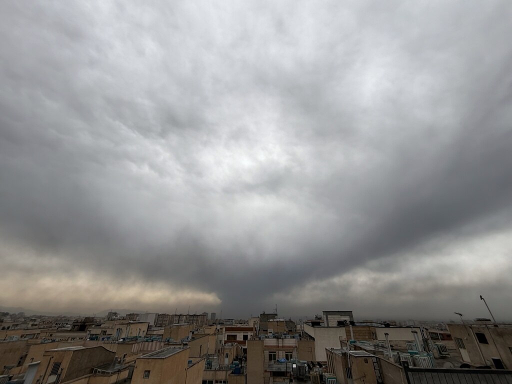 Plumes of smoke from a U.S.-Israeli strike on an oil facility late Saturday linger and merge with the cloudy sky over Tehran, Iran, Sunday, March 8, 2026. (AP Photo/Vahid Salemi)