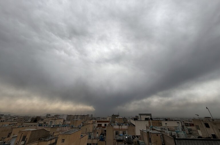 Plumes of smoke from a U.S.-Israeli strike on an oil facility late Saturday linger and merge with the cloudy sky over Tehran, Iran, Sunday, March 8, 2026. (AP Photo/Vahid Salemi)