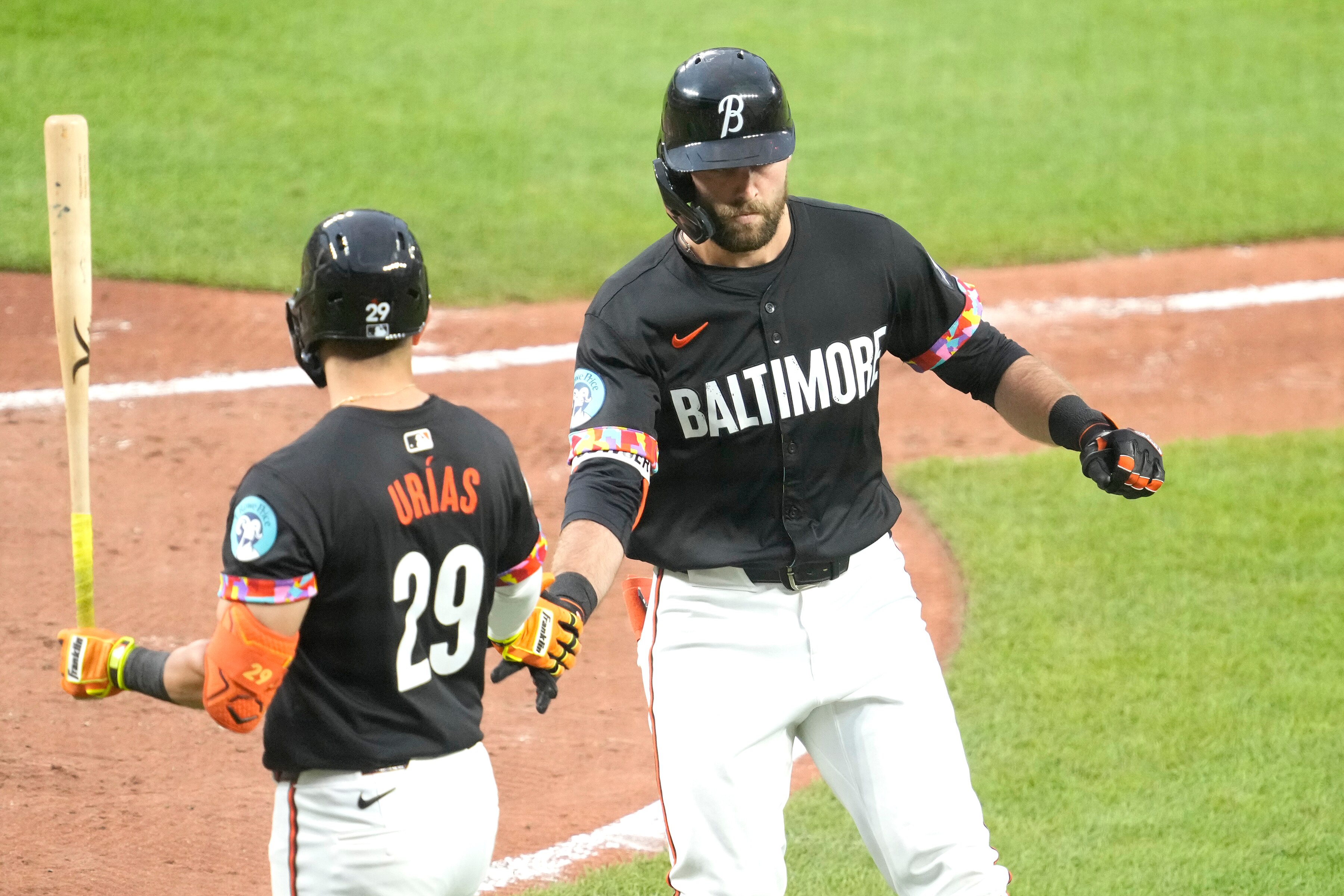 Colton Cowser (right) celebrates a solo home run in the fourth inning Friday night with Ramón Urías.