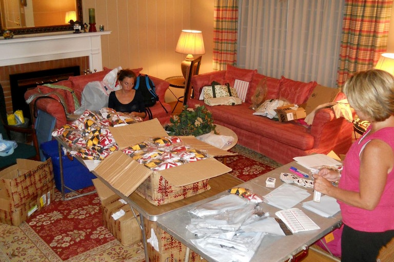 Following an influx of orders for her first piece of Maryland state flag merchandise, Ali Von Paris packages Maryland flag bikinis with her mother.