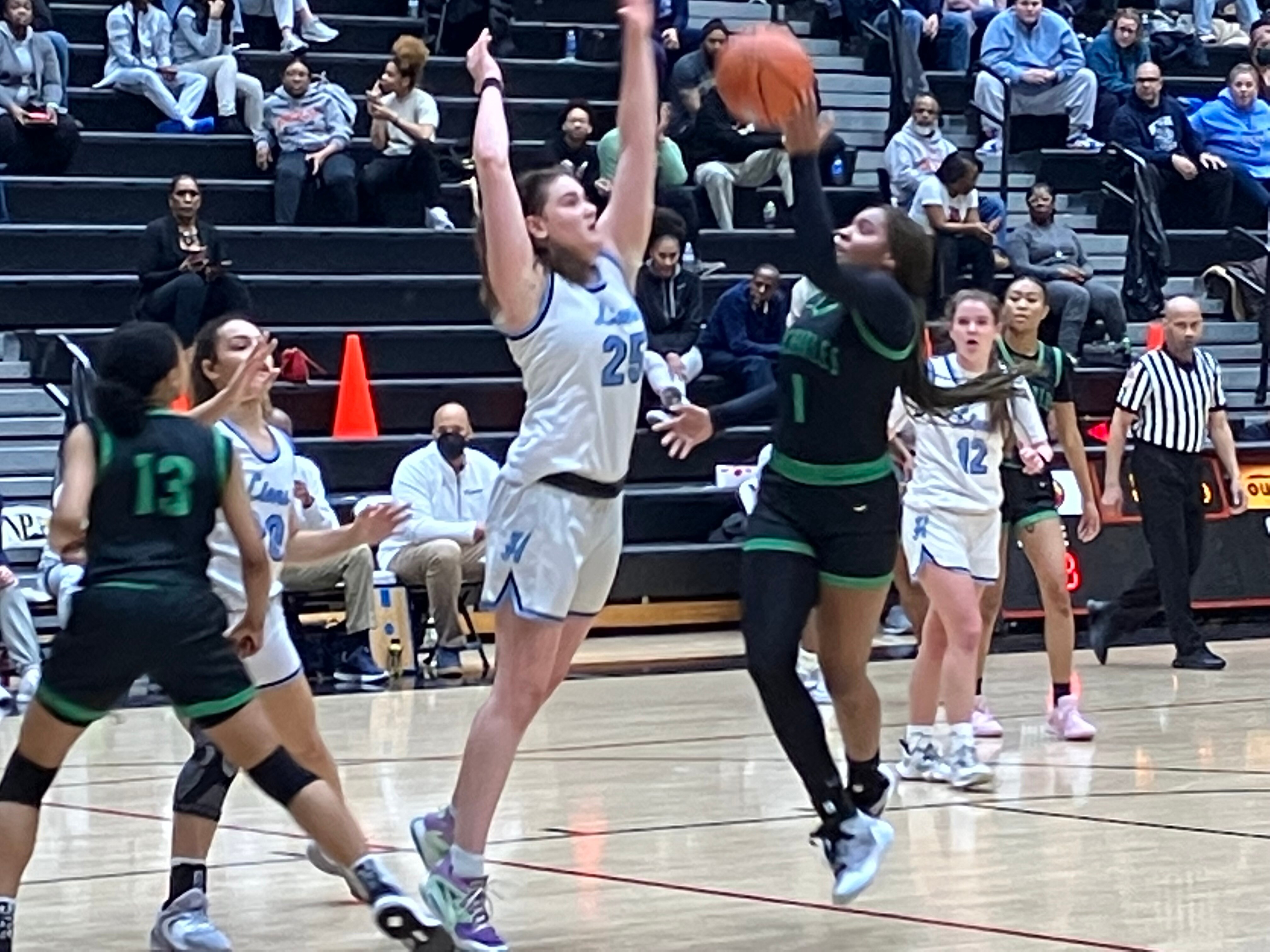 Andy StatesHoward's Meghan Yarnevich (25) defends as St. Charles' MIa Johnson attempts a shot during Tuesday's Class 3A state girls basketball semifinal. The fifth-ranked Lions advanced to the state final with a 67-31 victory at North Point in Charles County.