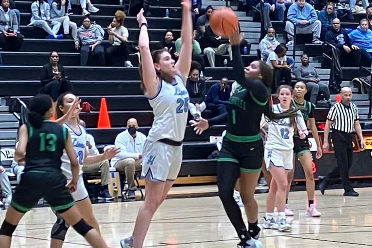 Andy StatesHoward's Meghan Yarnevich (25) defends as St. Charles' MIa Johnson attempts a shot during Tuesday's Class 3A state girls basketball semifinal. The fifth-ranked Lions advanced to the state final with a 67-31 victory at North Point in Charles County.