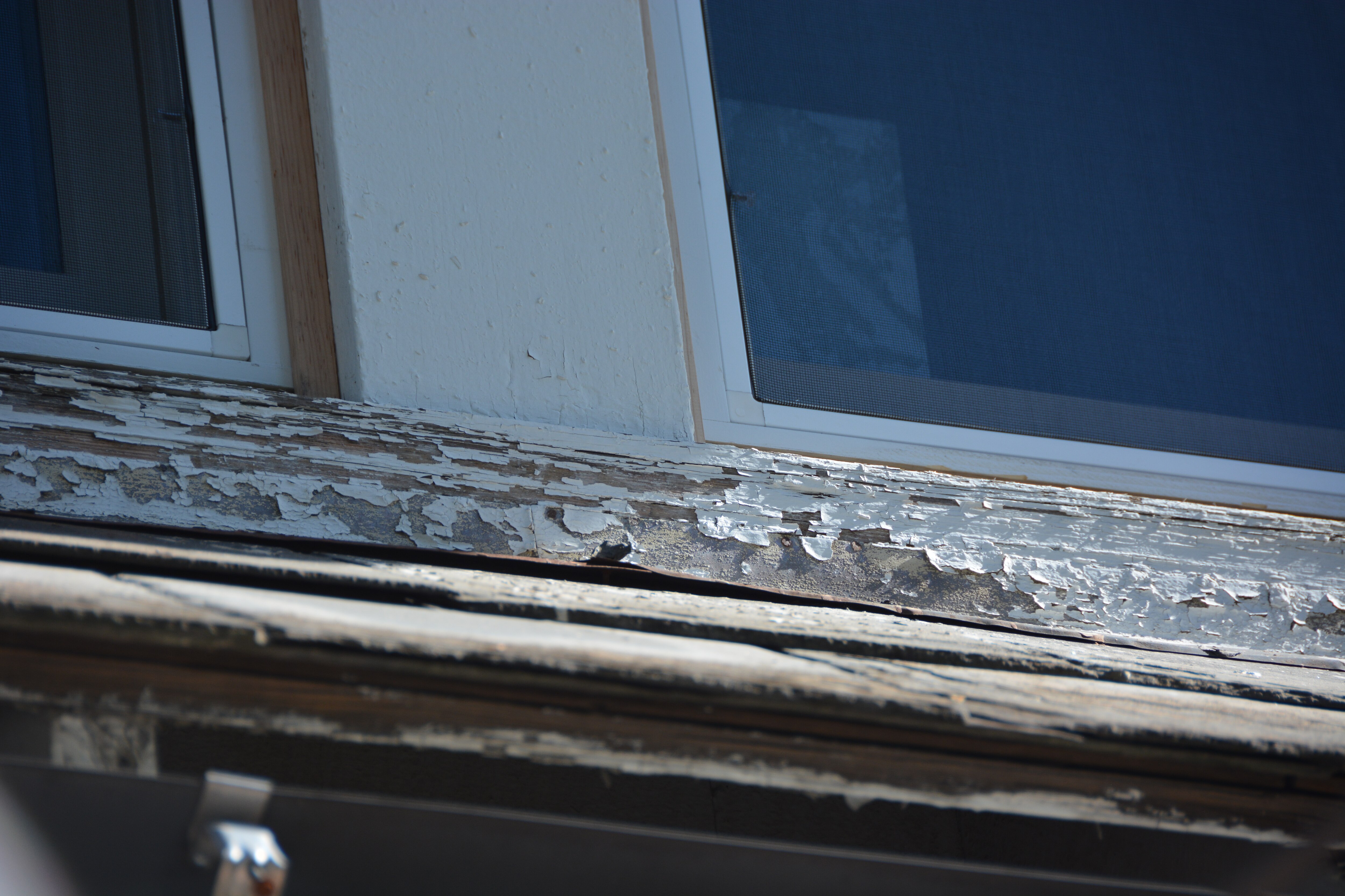 Lead paint peels on the exterior trim of a home in Baltimore City.