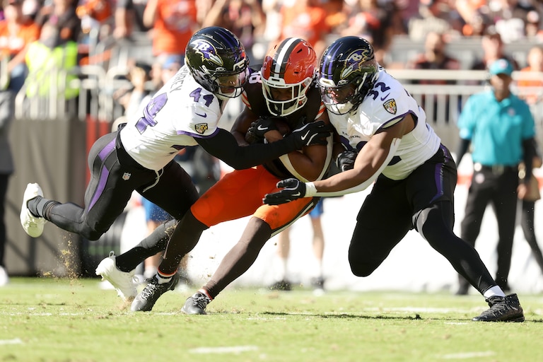 Baltimore Ravens cornerback Marlon Humphrey (44) and linebacker Trenton Simpson (32) combine to tackle Cleveland Browns running back Jaleel McLaughlin (38) during an NFL football game in Cleveland, Sunday, Oct. 18, 2026. (AP Photo/Kirk Irwin)