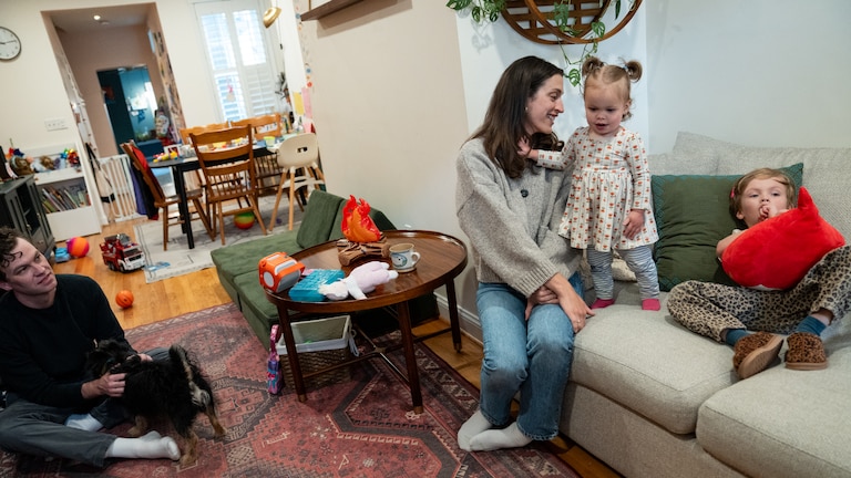 SUNDAY, MAY 24, 2026 - Molly Garcia, 34, husband Neil Gavigan, 36, and their children August Garcia-Gavigan, 4, and Lucy Garcia-Gavigan, 15 months, at their home in Baltimore. August wasn’t offered a spot in a Baltimore City Public School earlier this month, leaving the family to decide whether to wait as late as this summer for another chance or shell out $22,000 for another year of childcare.