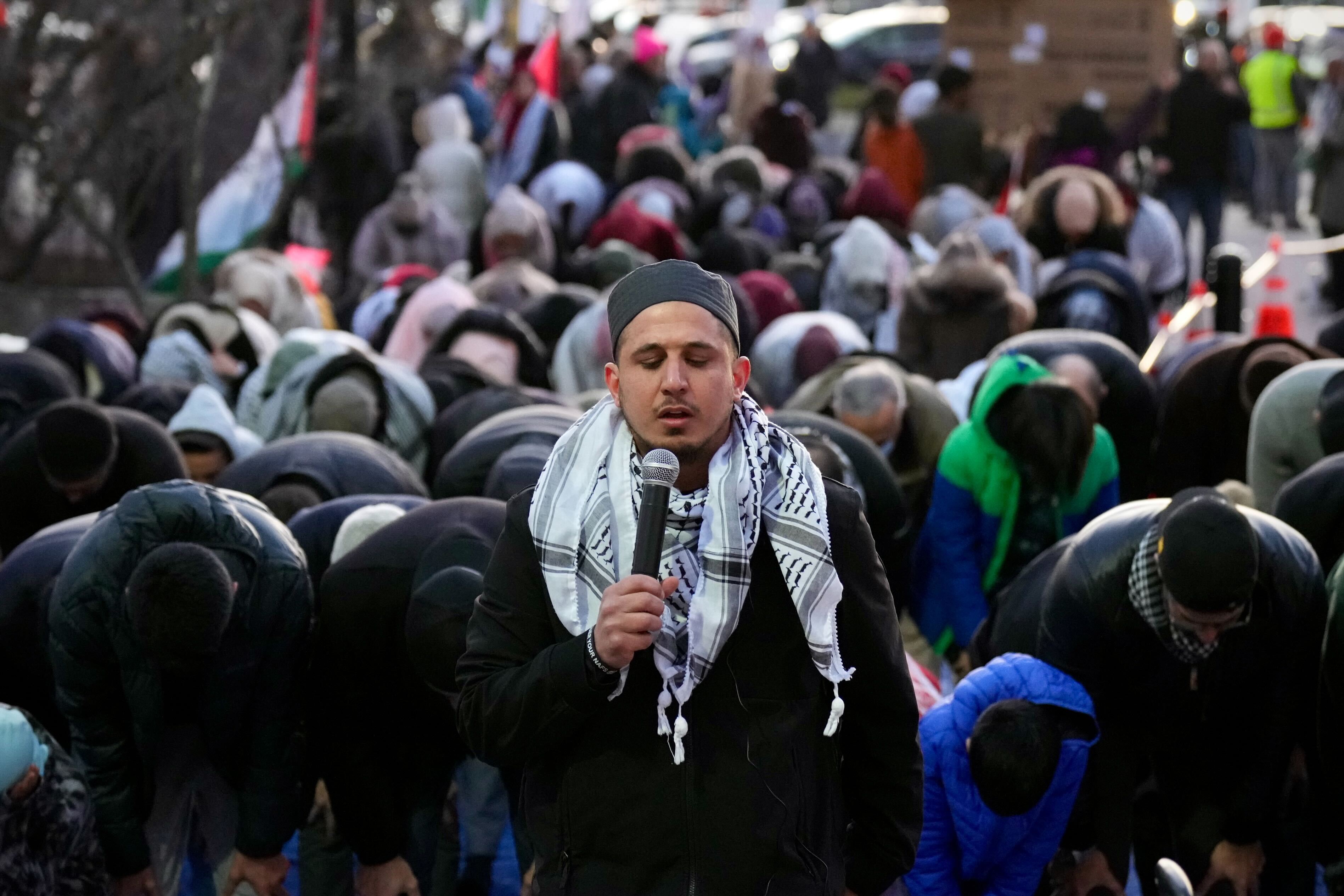 Sami Elzaharna, Imam of the Muslim Family Center in Columbia, leads a prayer outside the George Howard building in Ellicott City.