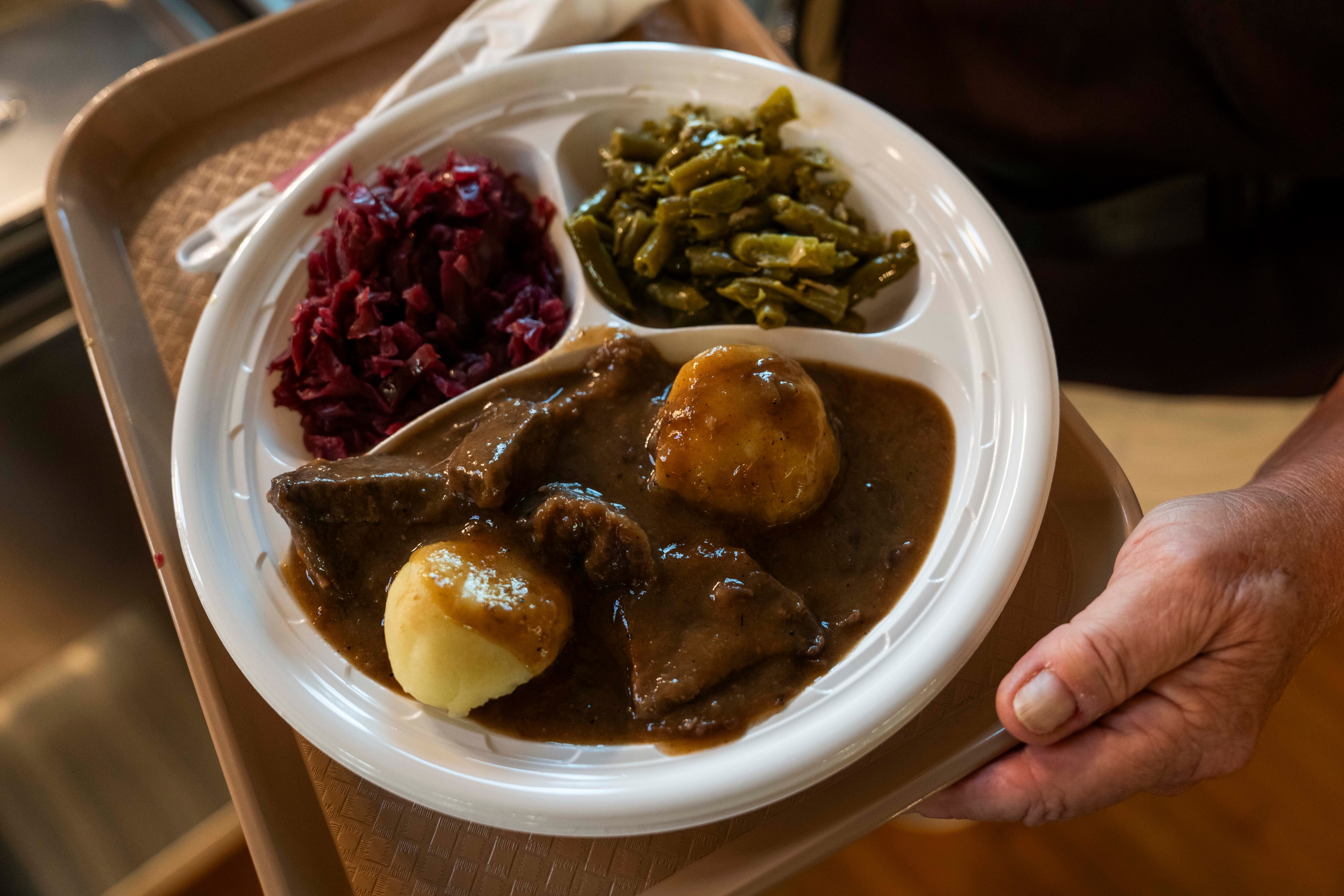 Sour beef, served with green beans and dumplings.