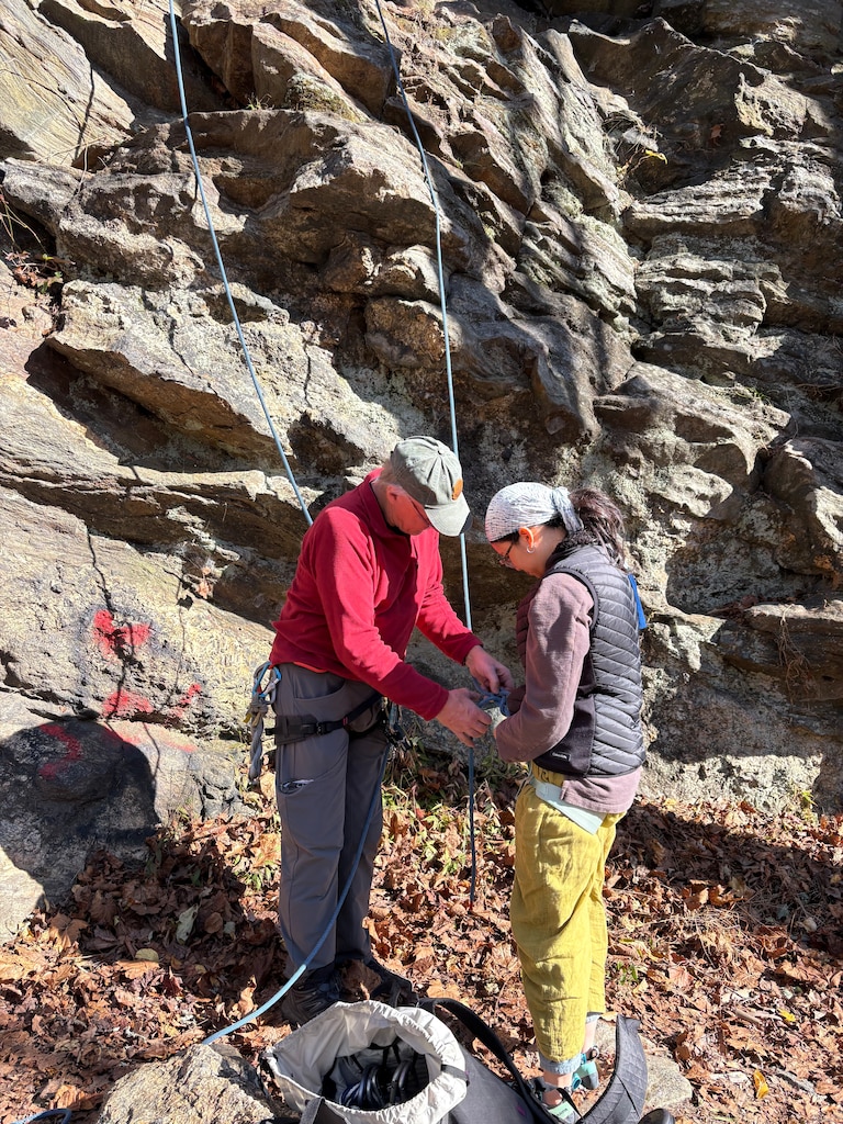 Mark “Indy” Kochte, the author of the guidebook A Guide to Climbing in Central Maryland, belays the rope for Meiyan Dong, who was hoisting herself up a boulder.
