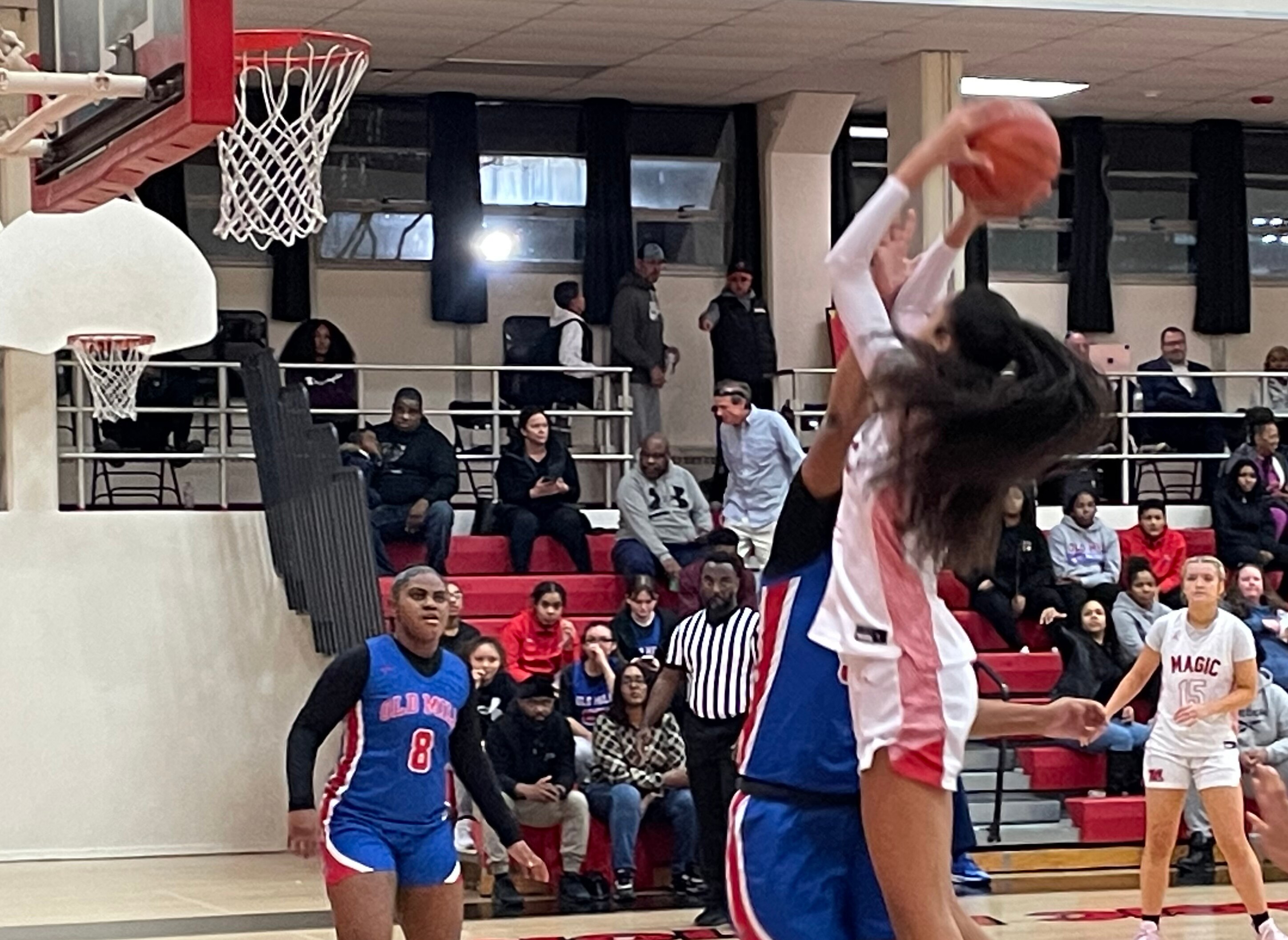 Mercy's Myah Hazelton shoots over Old Mill's Amani Watts in Tuesday night's 57-52 Mercy win. Hazelton, a 6-4 center/forward, finished with 27 points to lead the No. 7 Magic to victory over the No. 8 Patriots. Hazelton, a transfer from Sparrows Point, hit 11 of 14 shots including two 3-pointers.