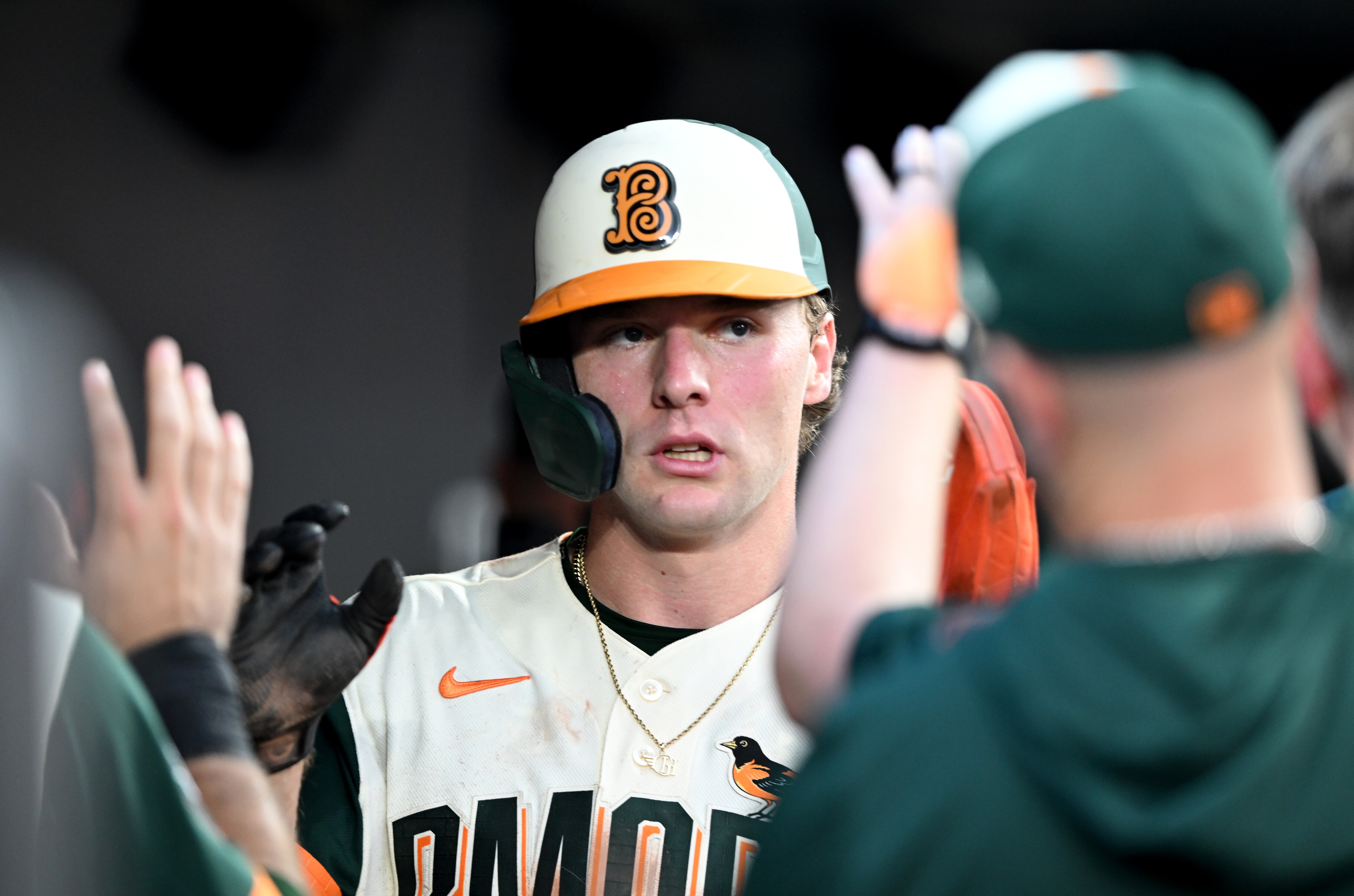 Gunnar Henderson gets high-fives in the dugout after scoring a run in the second inning. He hit a home run in the fourth.