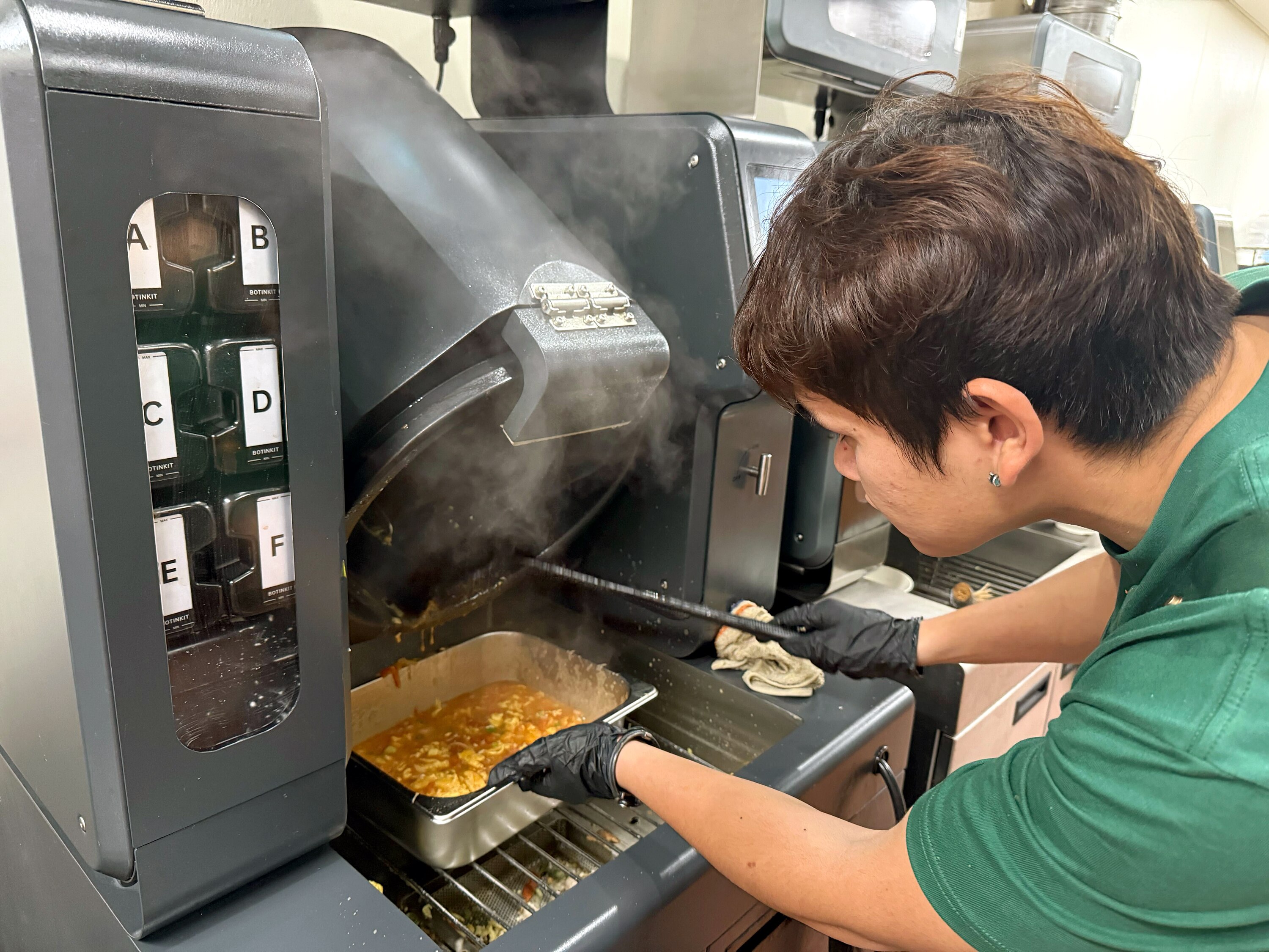 Mahjong just opened at 3105 St. Paul Street near Johns Hopkins University. A Mahjong staff member with the Botinkit robot.