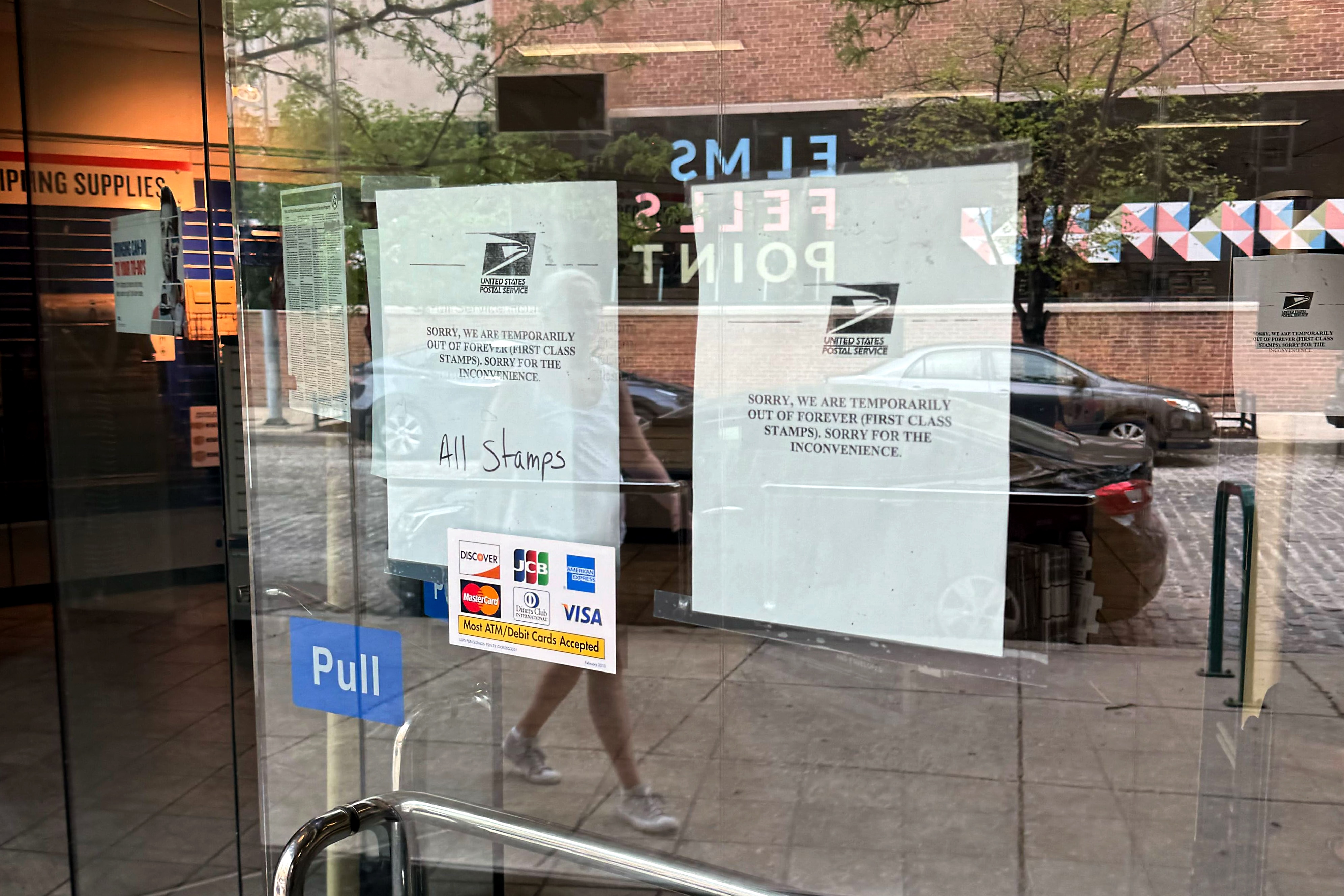 Signs on the door of the United States Postal Office in Fells Point at 714 S Wolfe Street in Baltimore note a lack of Forever stamps at the location.
