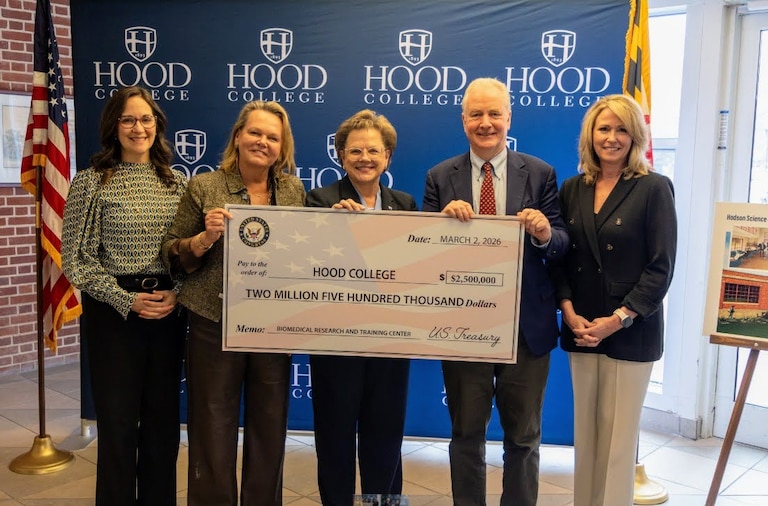 U.S. Rep. April McClain Delaney, Hood College President Debbie Ricker and U.S. Sen. Chris Van Hollen deliver a fake check for $2.5 million for a bio-check center.